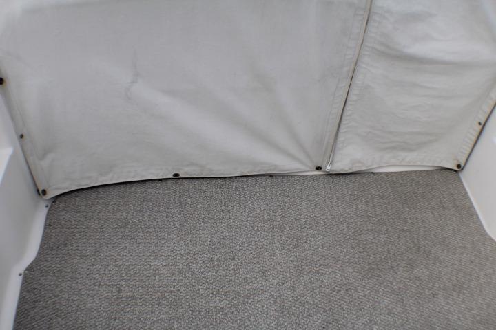 1998 Bayliner 2655 Ciera Sunbridge interior with gray carpet and white canvas cover.