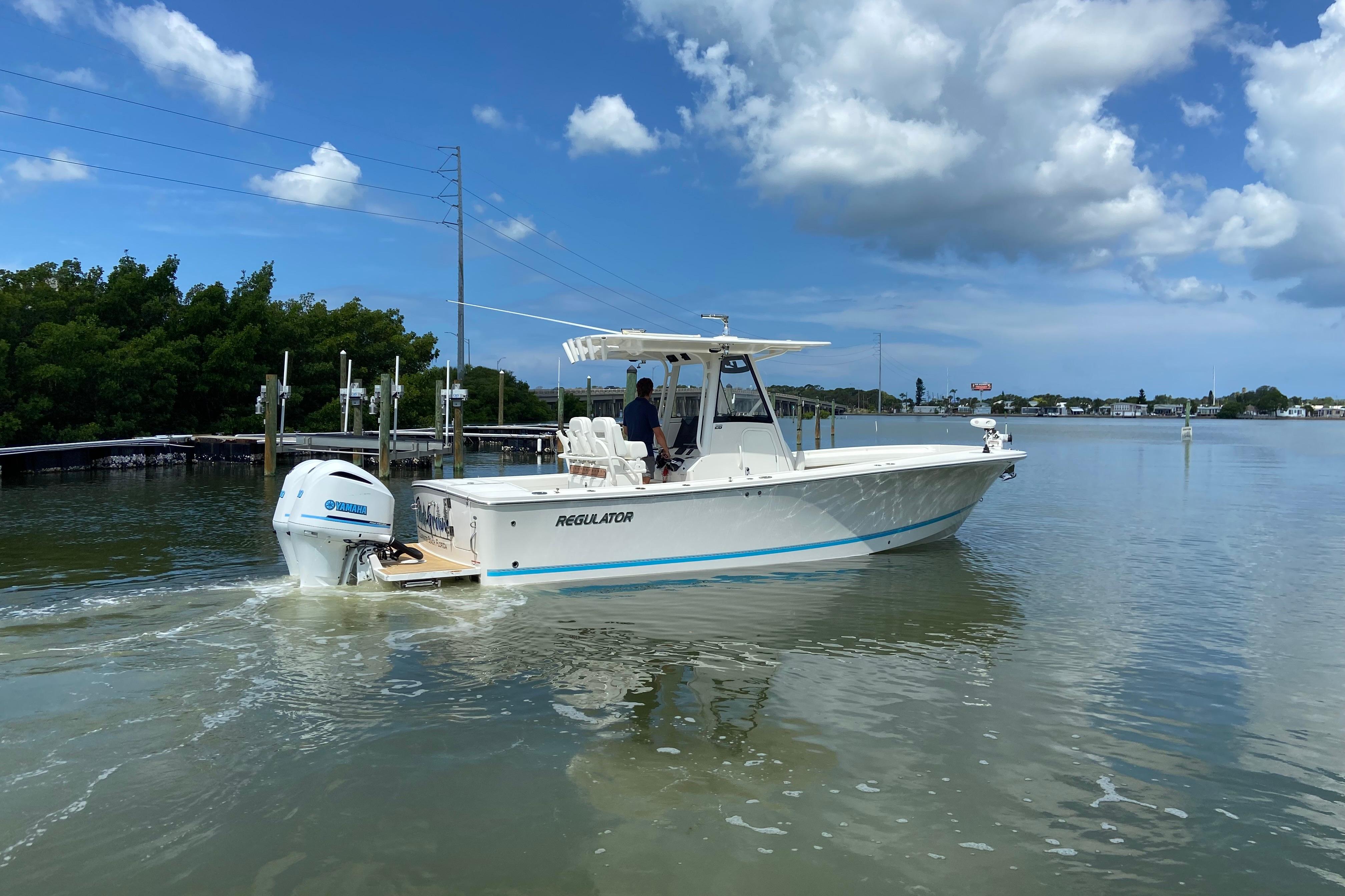 2021 Regulator 28 boat cruising on calm waters under a clear blue sky.