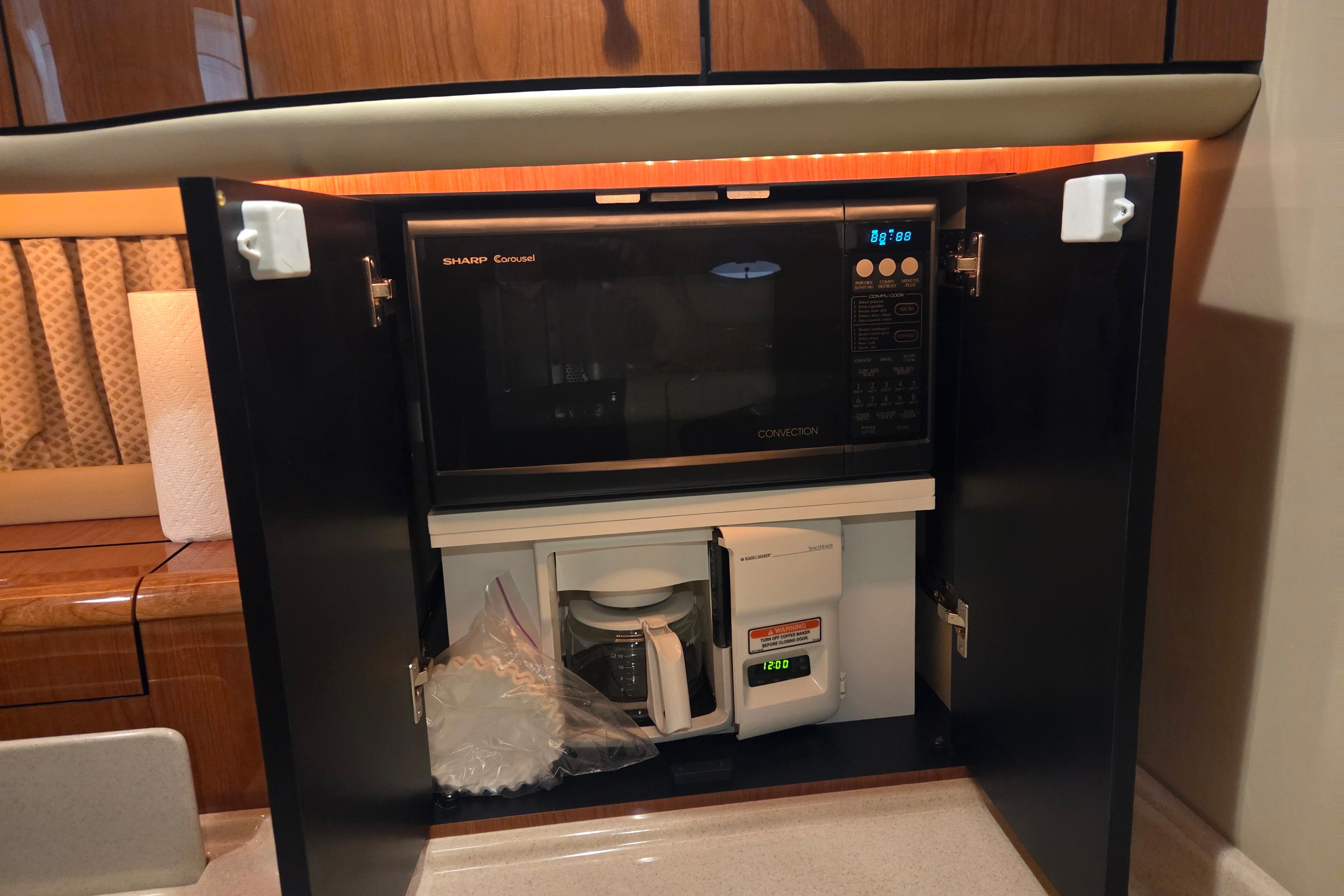 Microwave and coffee maker inside Sea Ray Sundancer 540 yacht's kitchen cabinet, 2000 model.