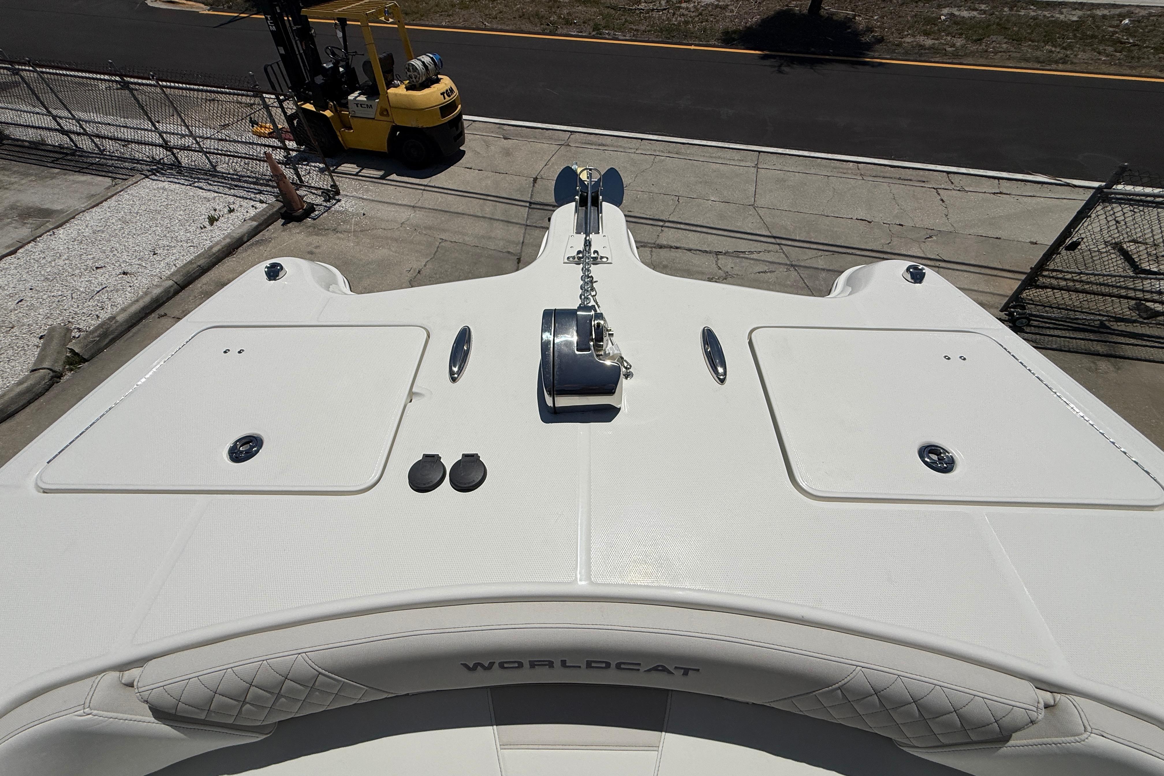 2026 World Cat 325 CC boat deck with anchor and storage compartments.