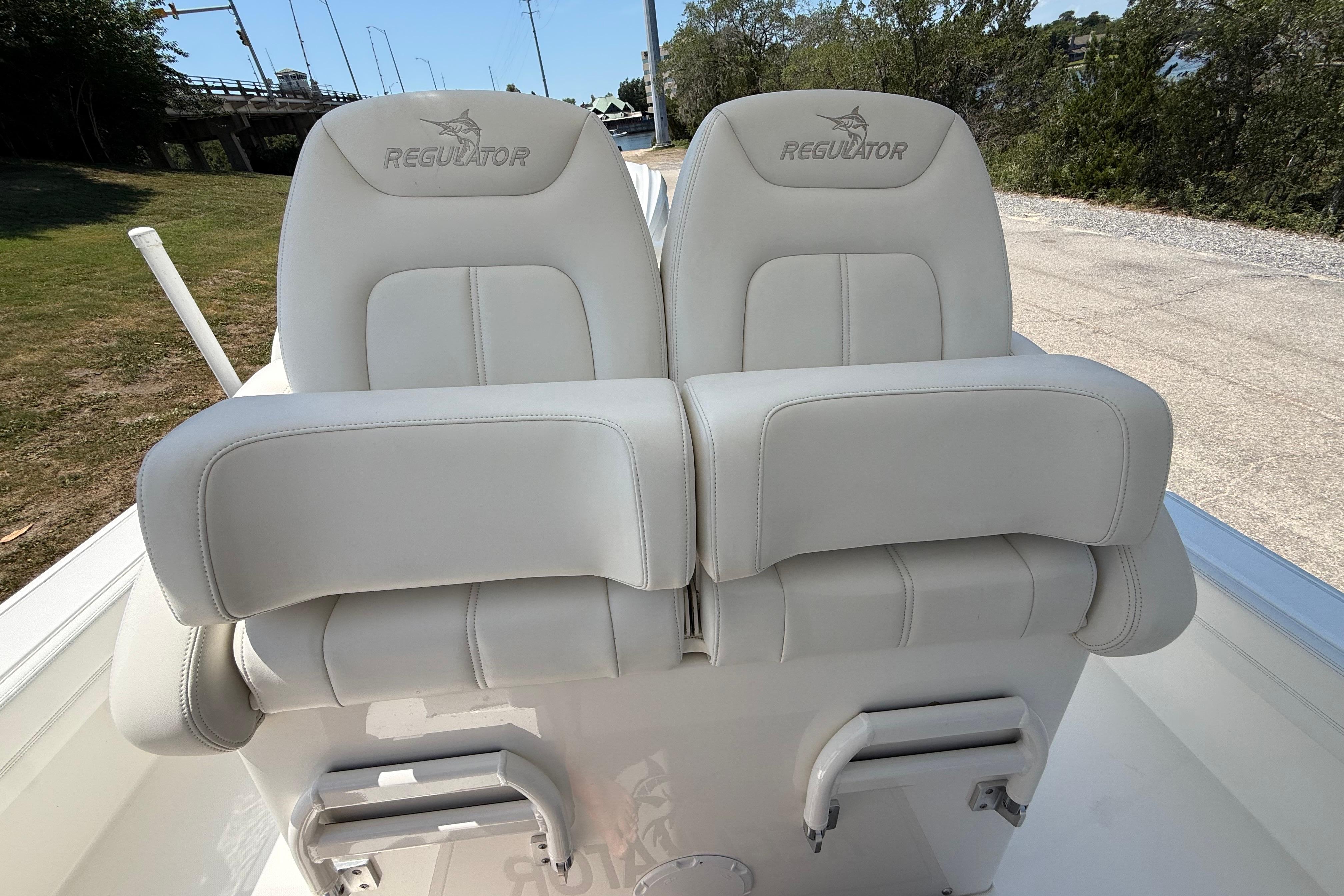 2023 Regulator 26XO boat seats, white leather, outdoor setting.