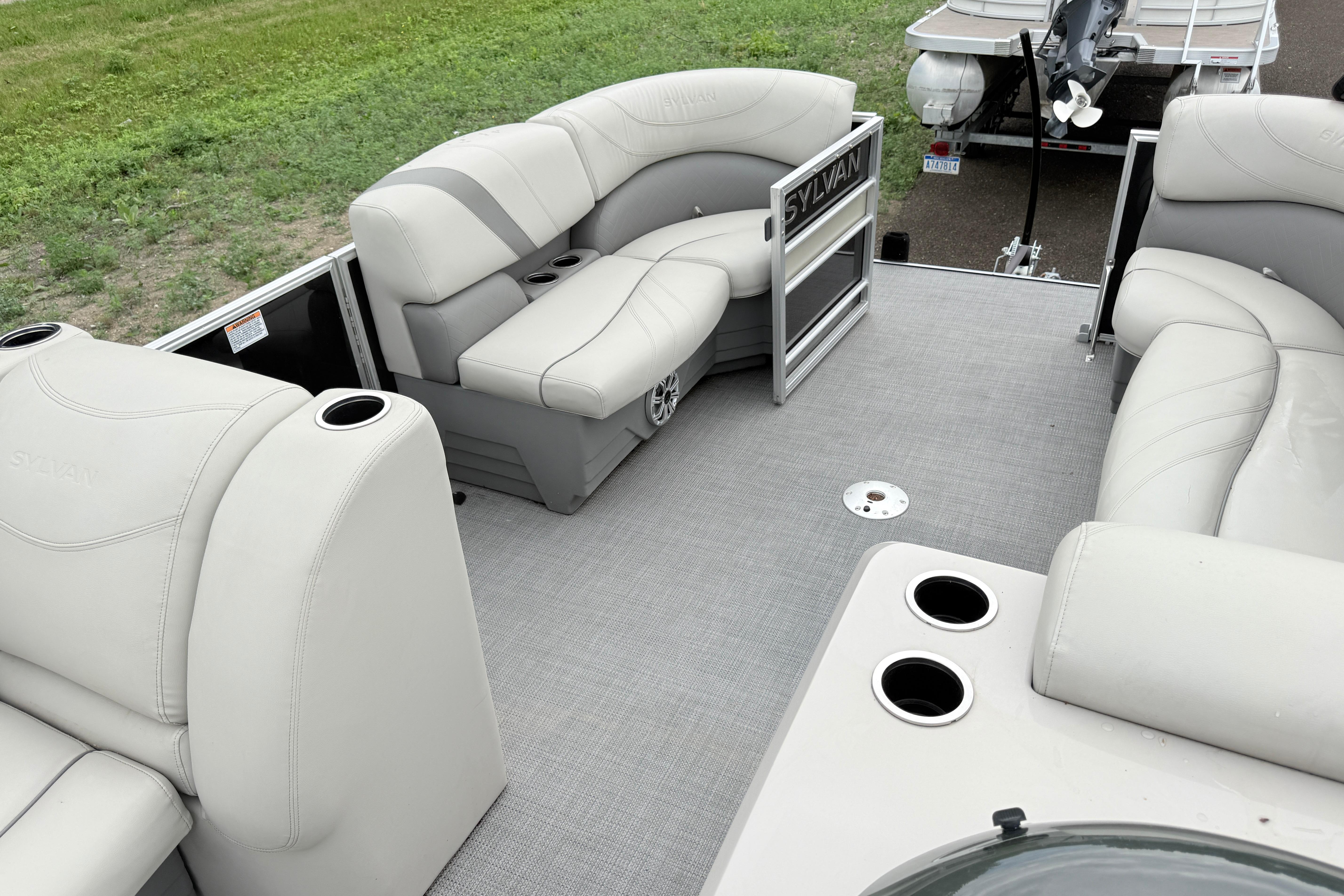2019 Sylvan 8522 Mirage Signature F-n-C pontoon boat interior with plush seating and cup holders.
