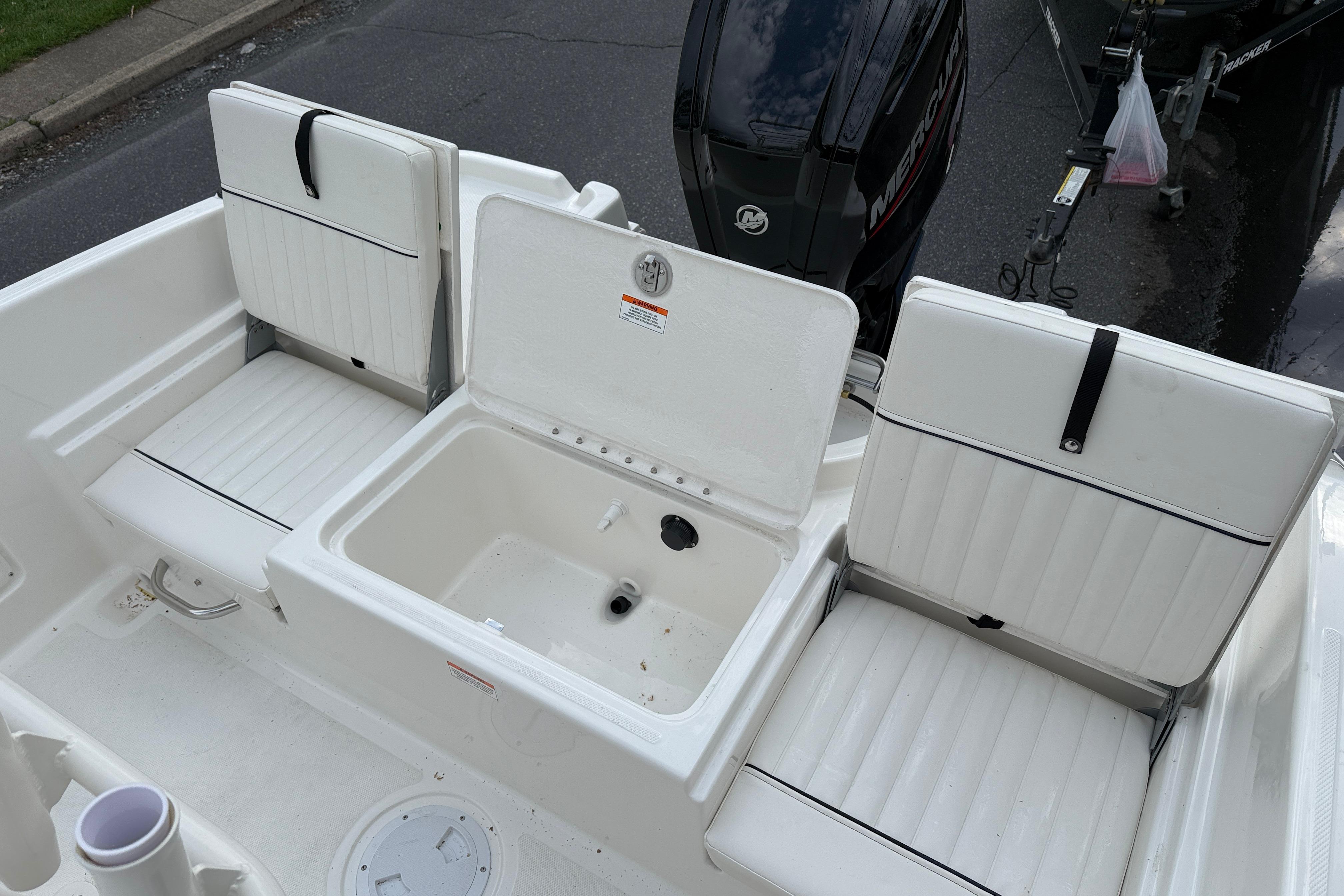 2026 Bayliner Trophy T18 boat interior with white seating and storage compartment.