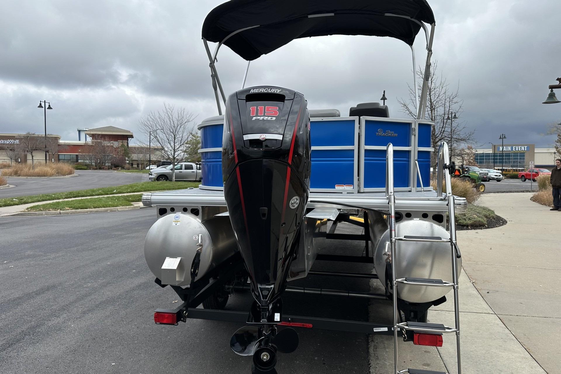 2026 Sun Tracker Party Barge 20 DLX with Mercury 115 Pro motor in parking lot.