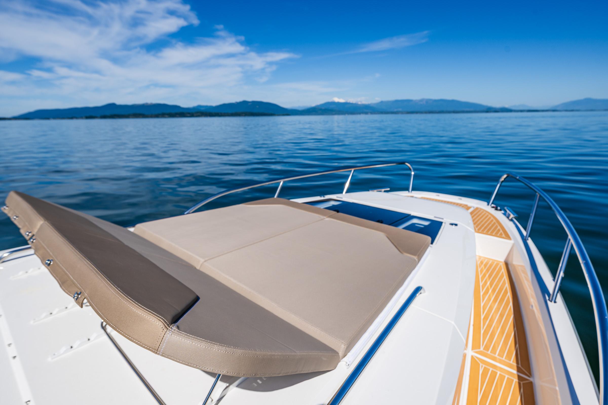 Luxurious Nimbus W11 2025 boat with sunbed on calm blue waters.