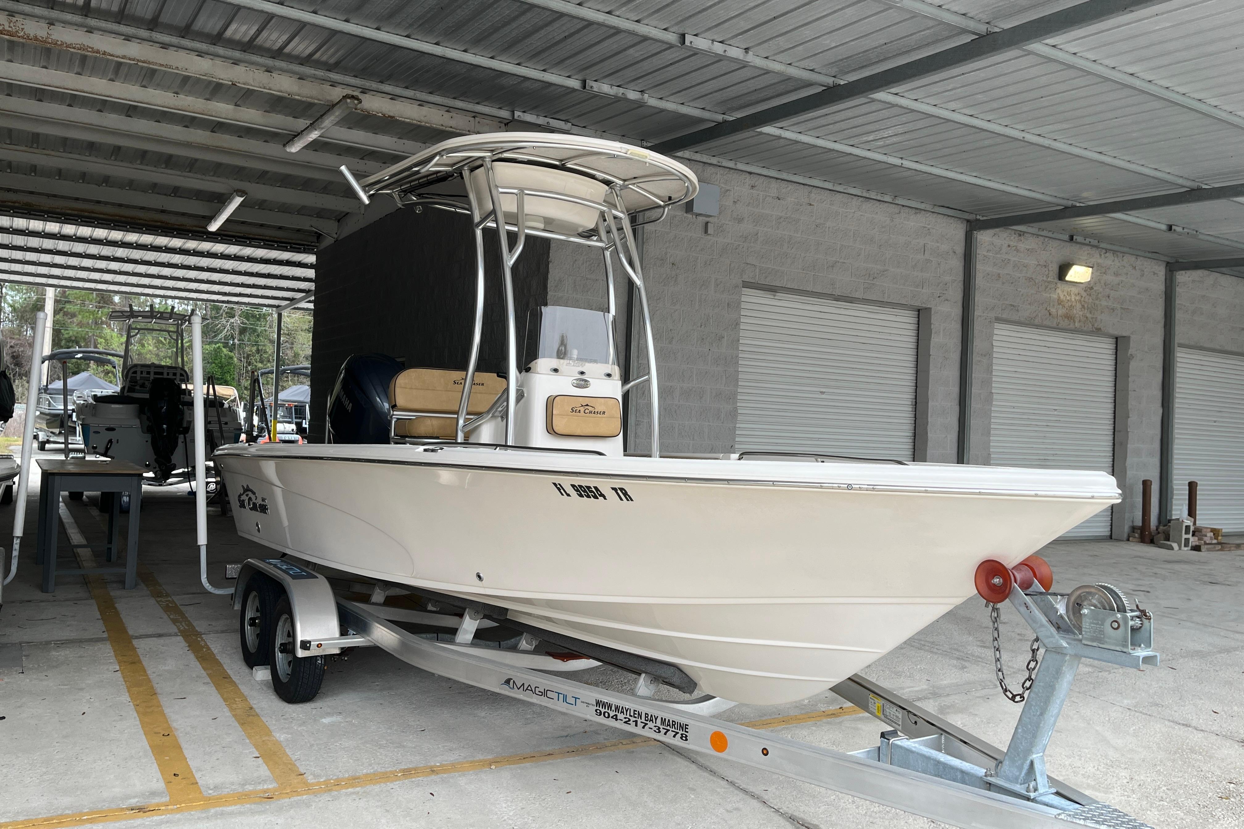 2024 Sea Chaser 21 LX boat on trailer in covered storage area.