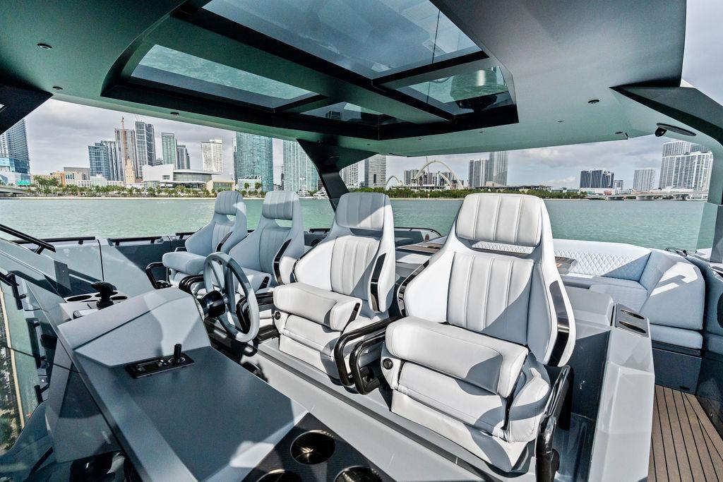 Luxurious 2024 Vanquish Yachts VQ55 interior with modern seating and city skyline view.