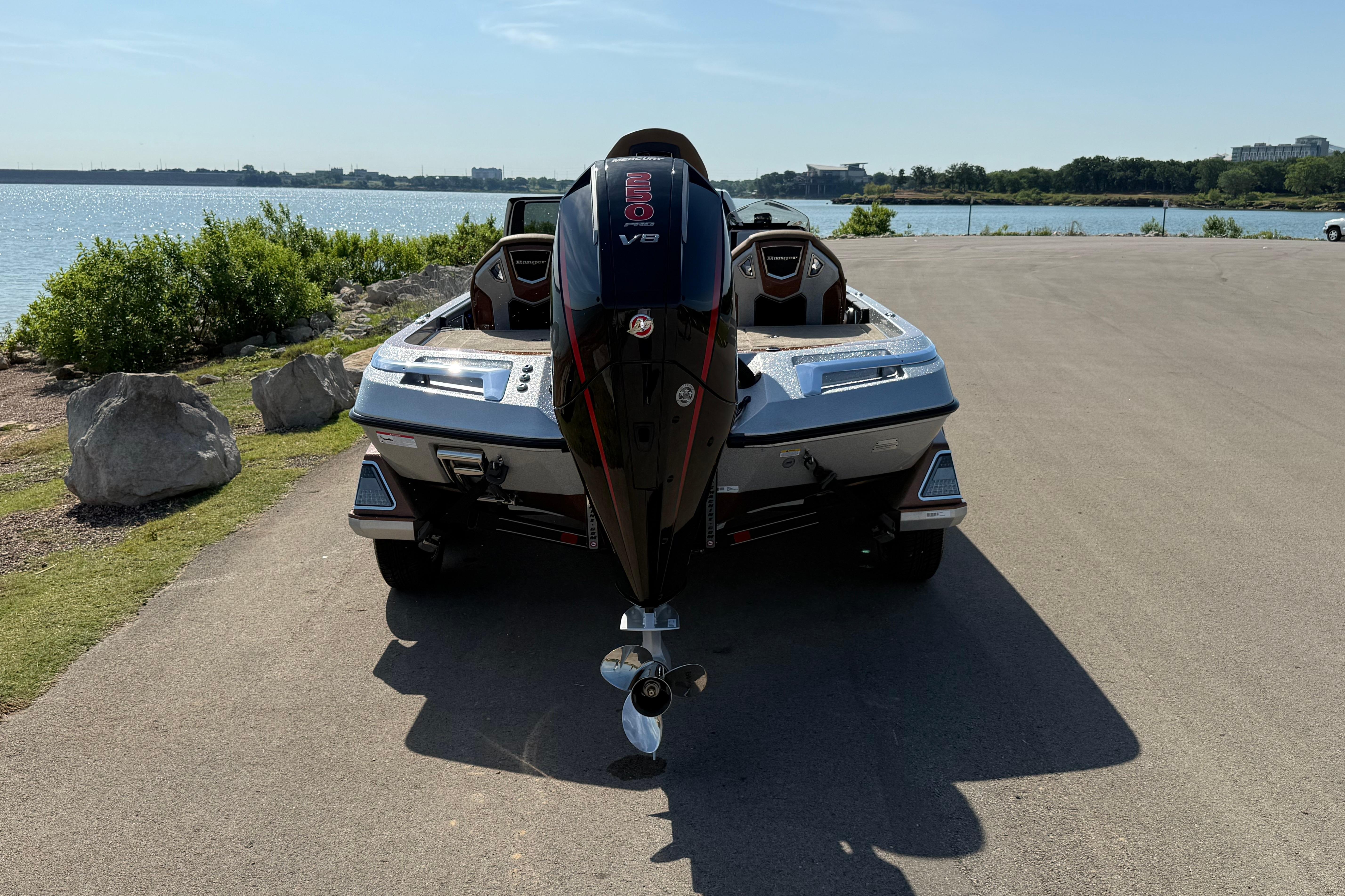 2026 Ranger Z521R boat with V8 engine, parked near a scenic lakeside view.