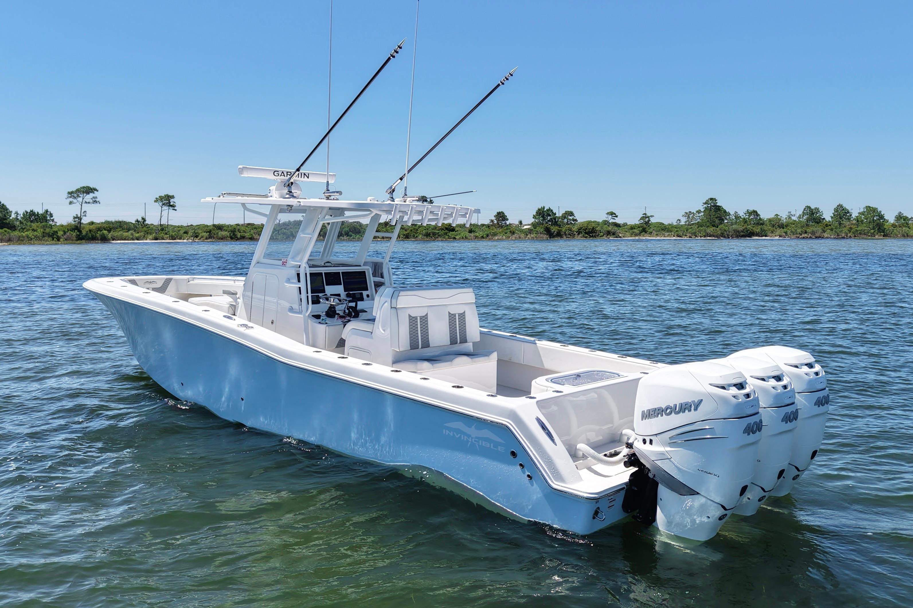 2023 Invincible 36 Open Fisherman boat with triple Mercury 400 engines on water.