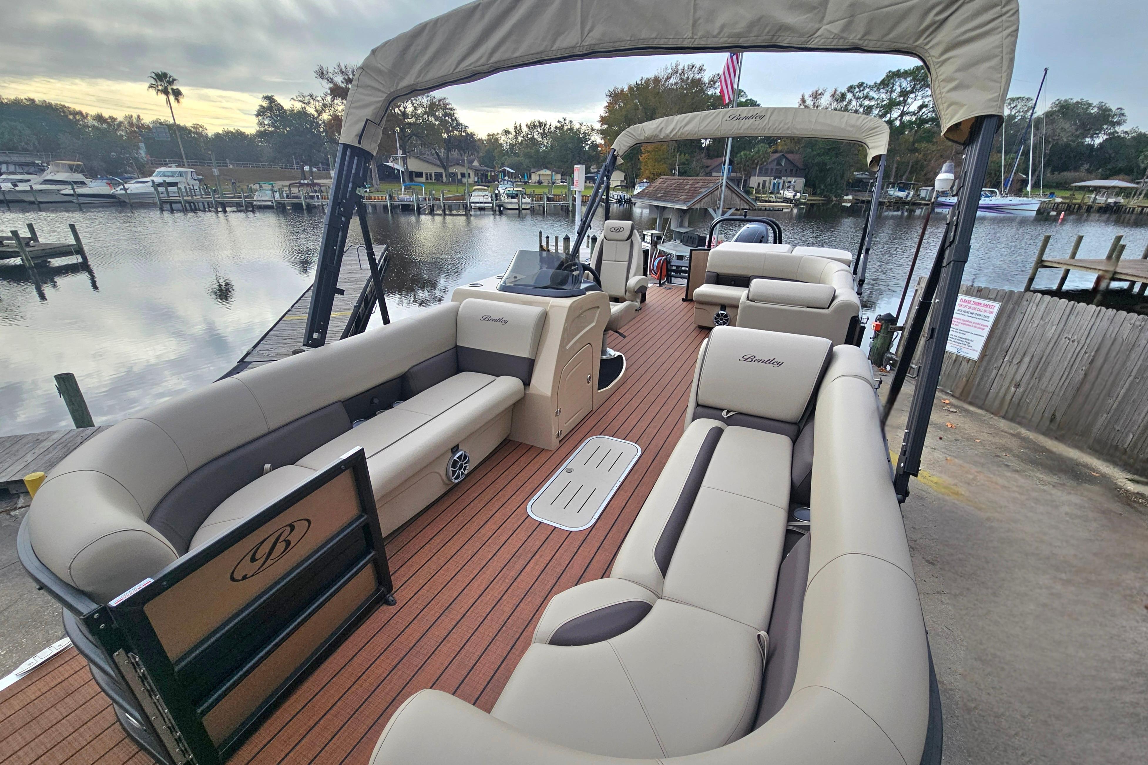 2026 Bentley Pontoons Legacy 243 Cruise on a serene waterfront dock.