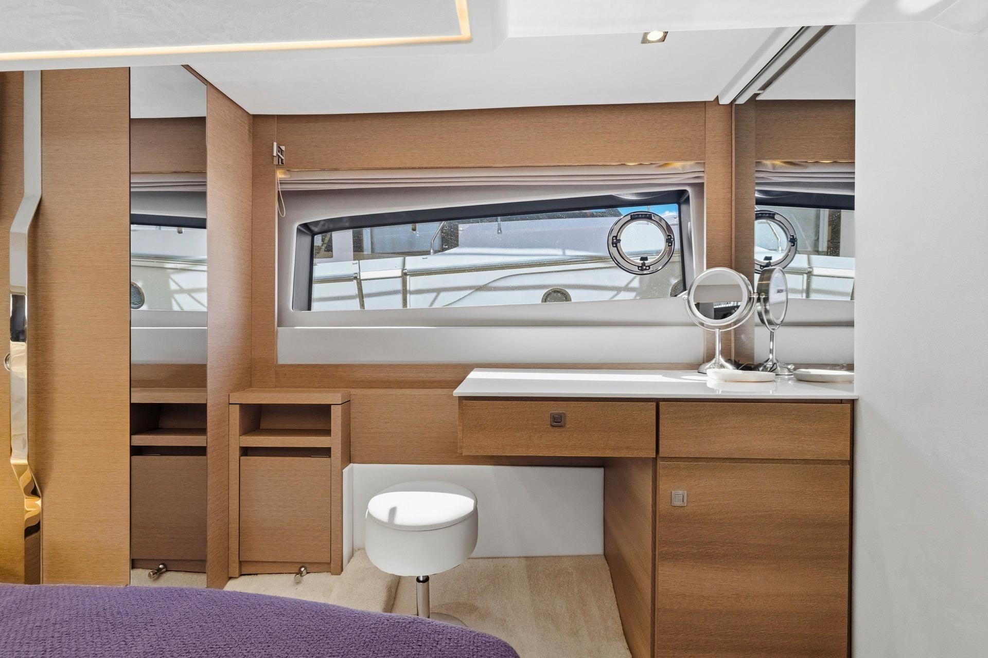 Luxurious interior of 2022 Prestige 520 yacht with vanity and seating.