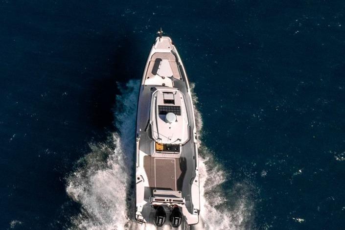 2025 Axopar 29 CCX cruising on open water, aerial view.