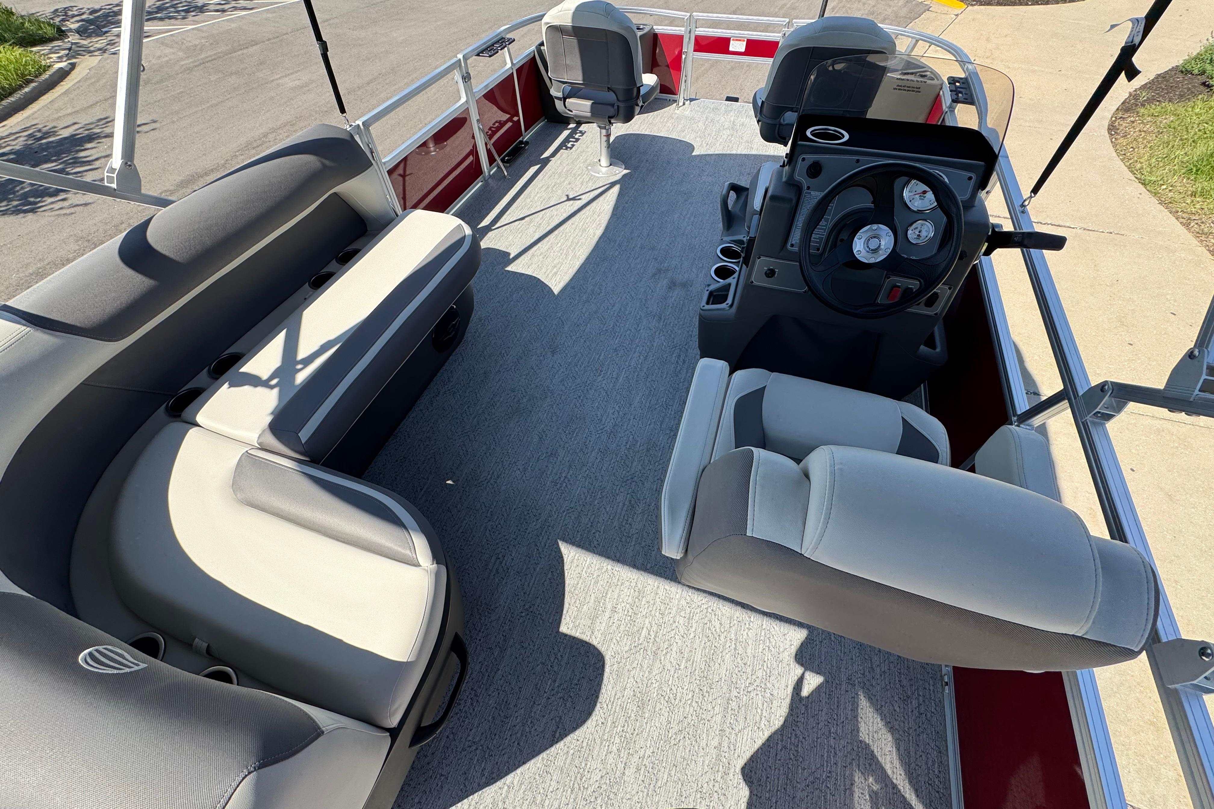 2026 Sun Tracker Bass Buggy 18 DLX pontoon boat interior with seating and steering console.