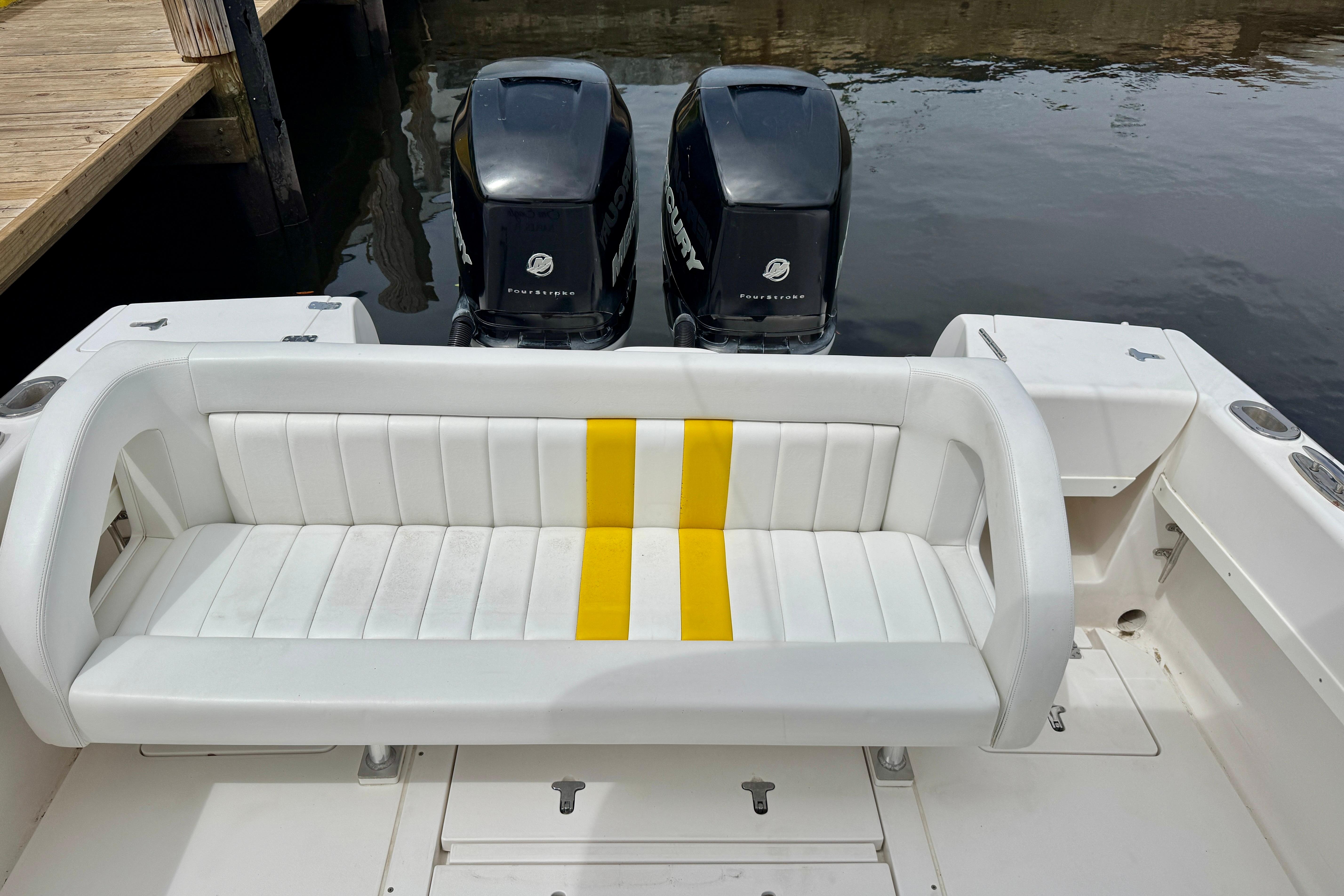 2013 Intrepid 300 Center Console boat with dual Mercury engines and white seating.