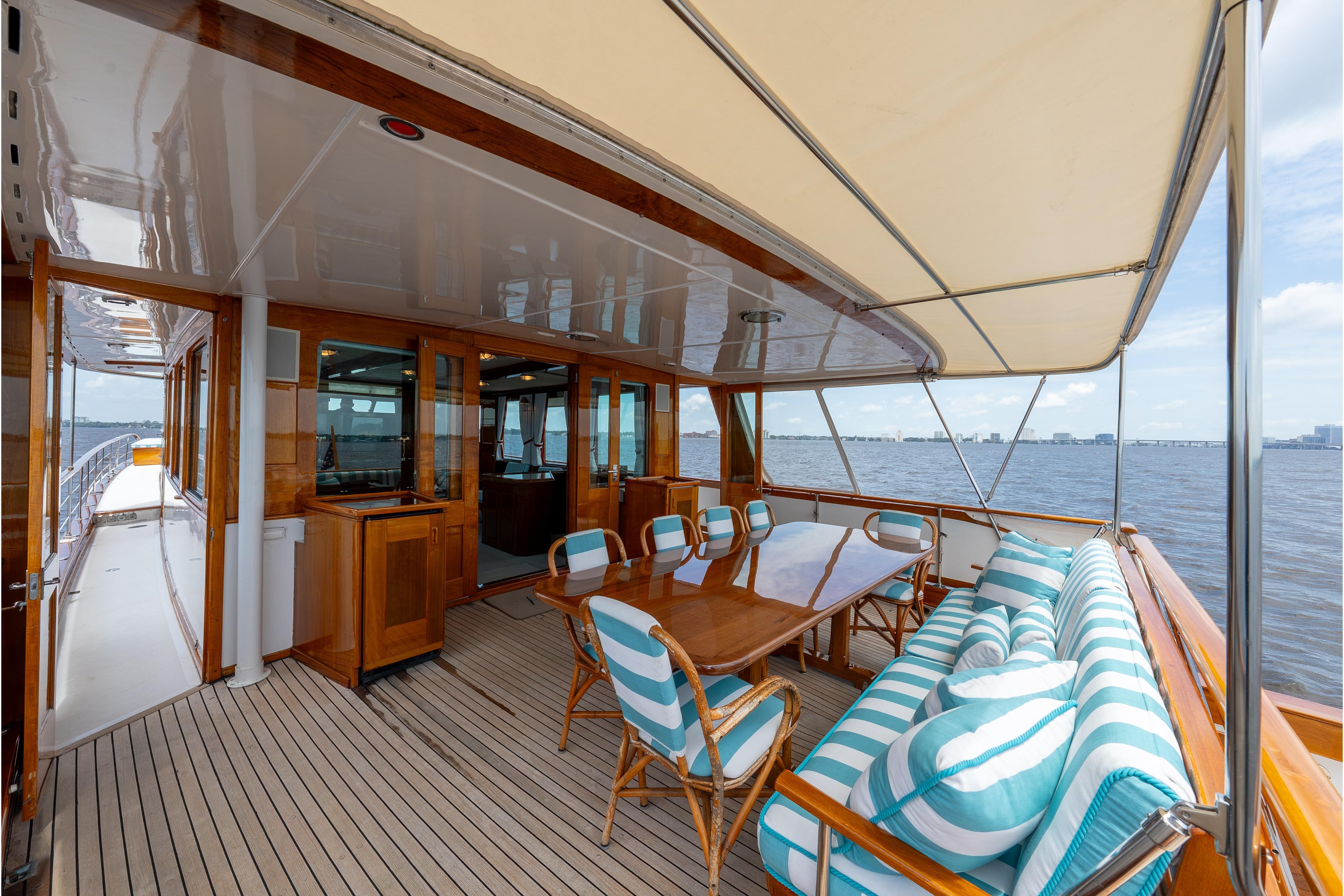 Luxurious 1963 Trumpy Classic yacht deck with elegant seating and ocean view.