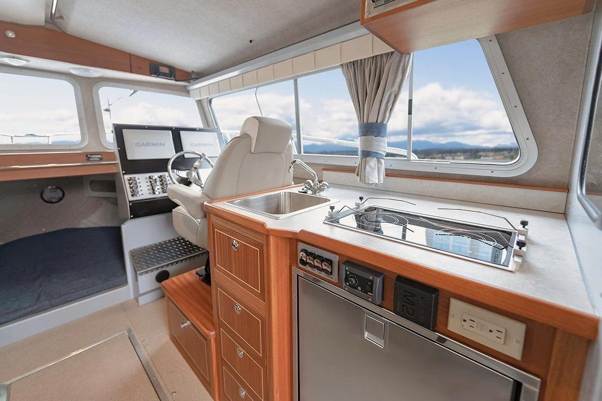 Interior of 2026 KingFisher 3225 GFX Offshore boat with modern kitchen and helm.