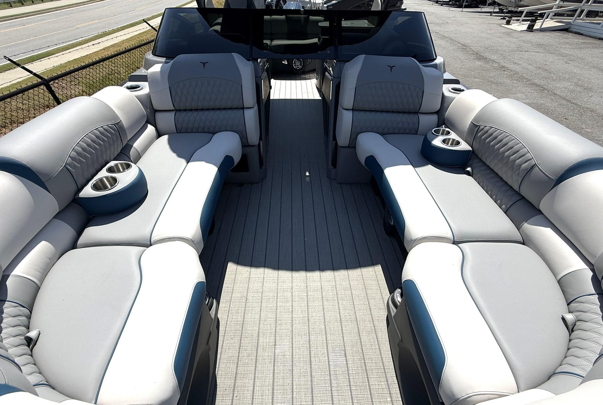 2025 Tahoe Pontoon Grand Tahoe Elite Windshield interior with luxurious seating and cup holders.