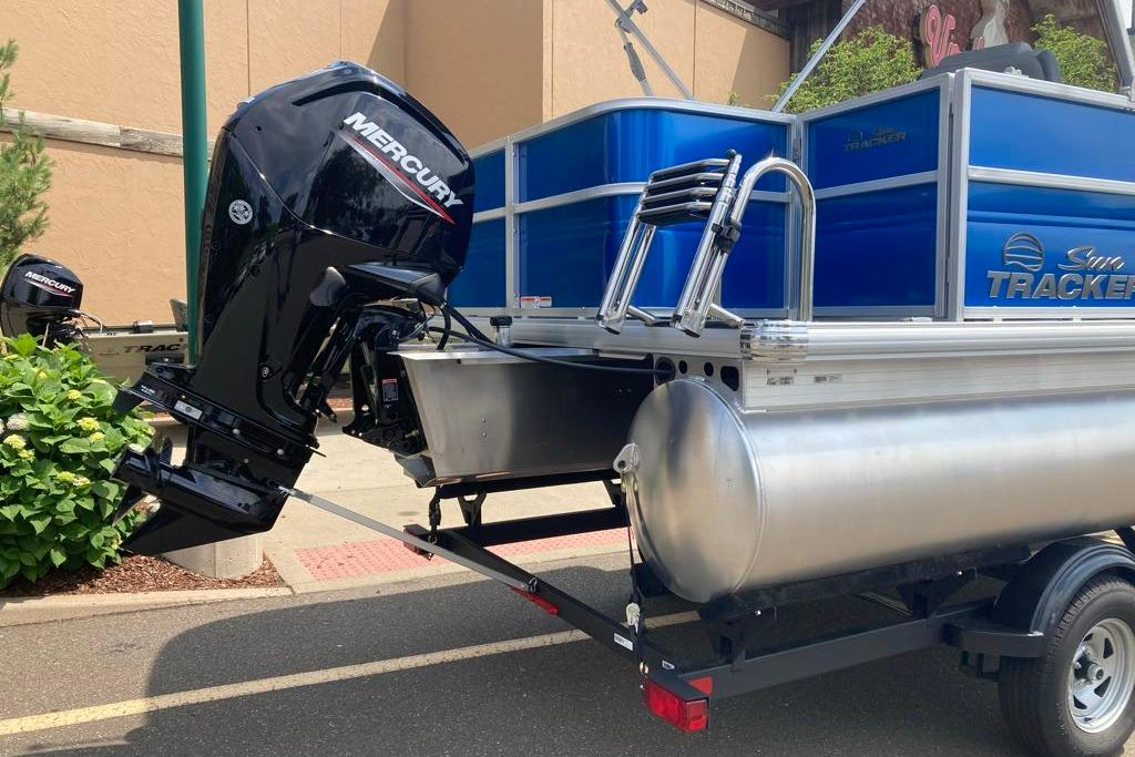 2026 Sun Tracker Party Barge 18 DLX with Mercury outboard motor on trailer.