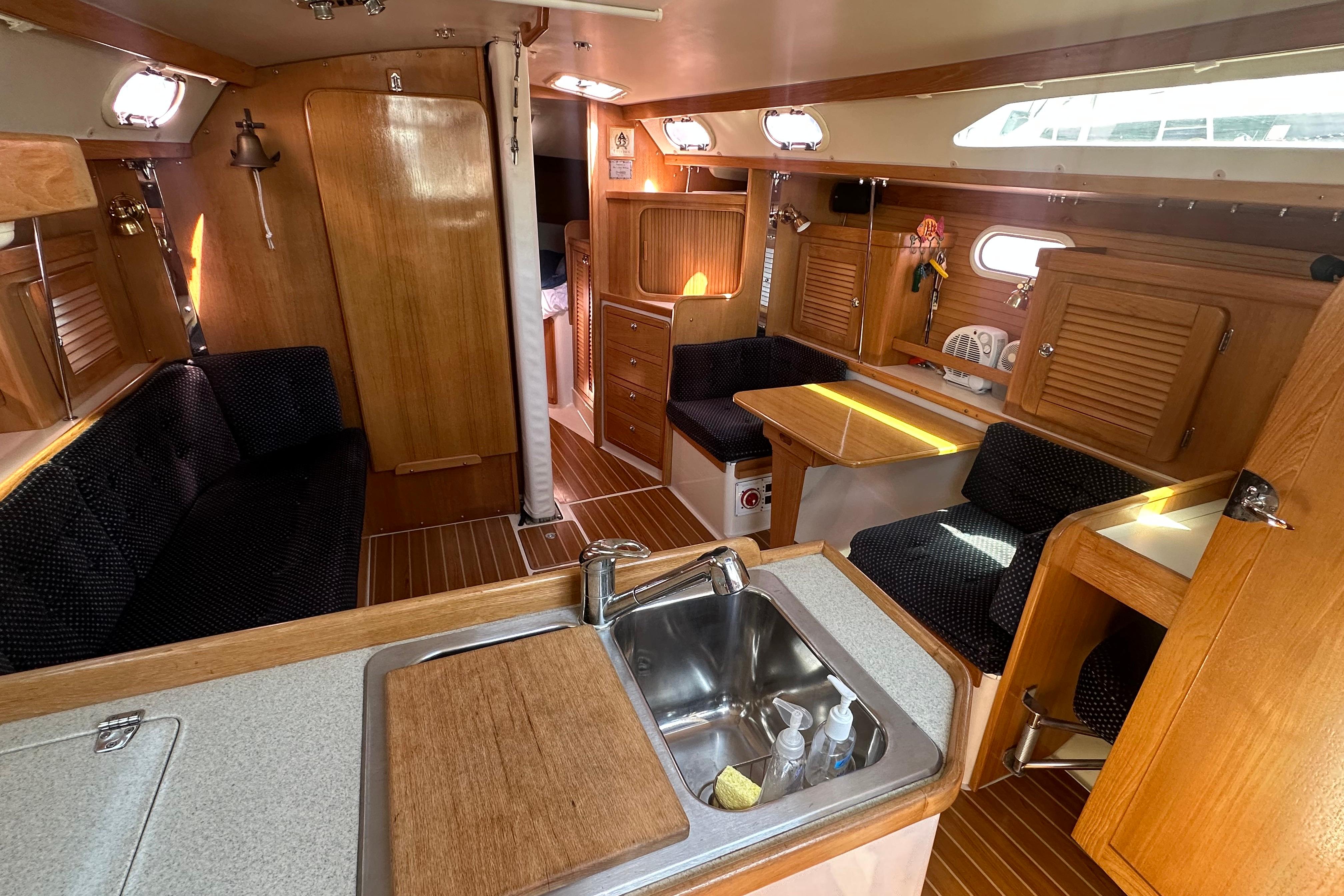 Interior of a 2005 Catalina 36 MkII sailboat with wood finishes and seating area.