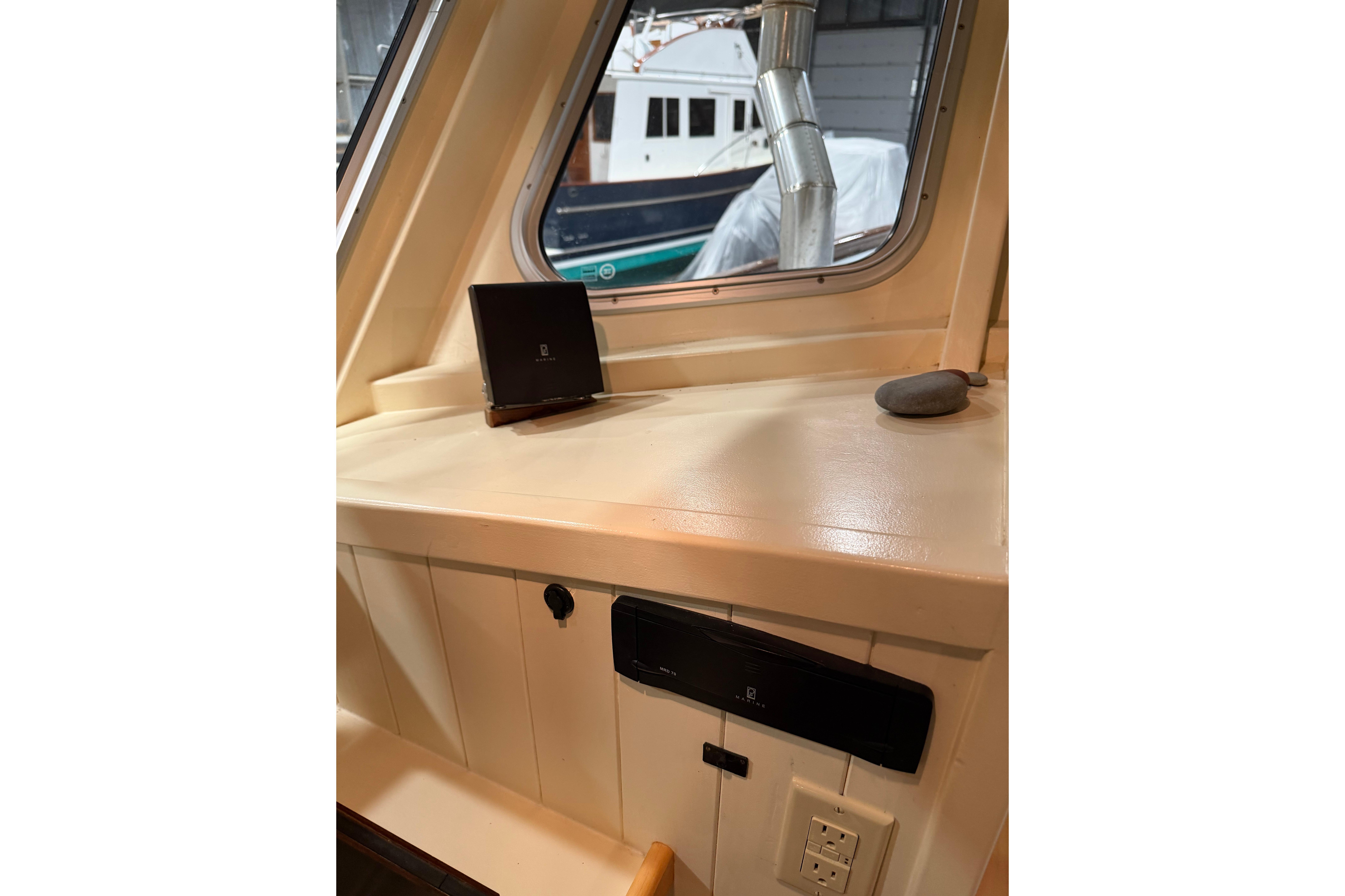Interior view of 2022 Covey Island 38 Lobster Yacht, featuring a control panel and window.