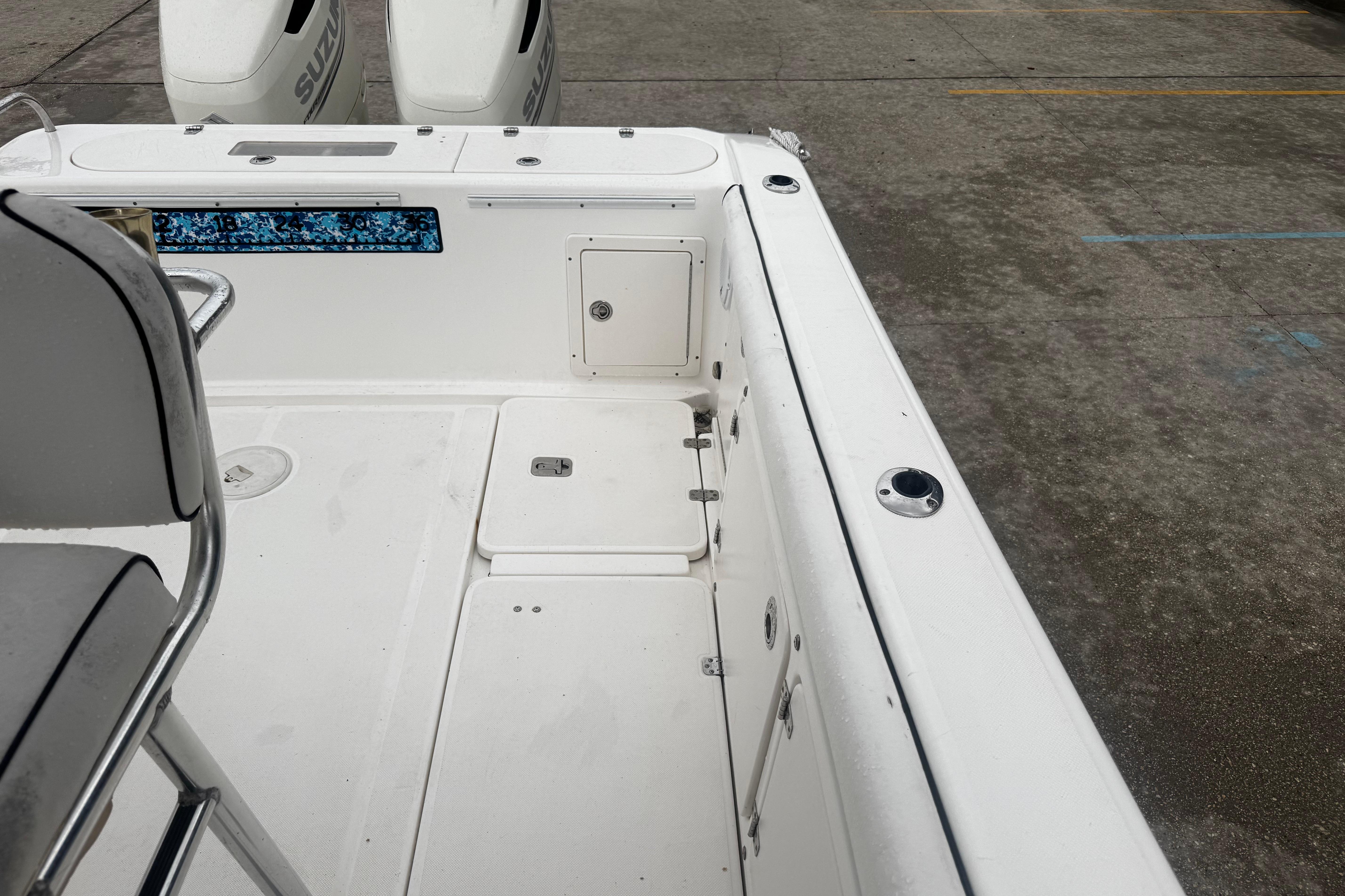 2004 Century 2900 Center Console boat interior with seating and storage compartments.