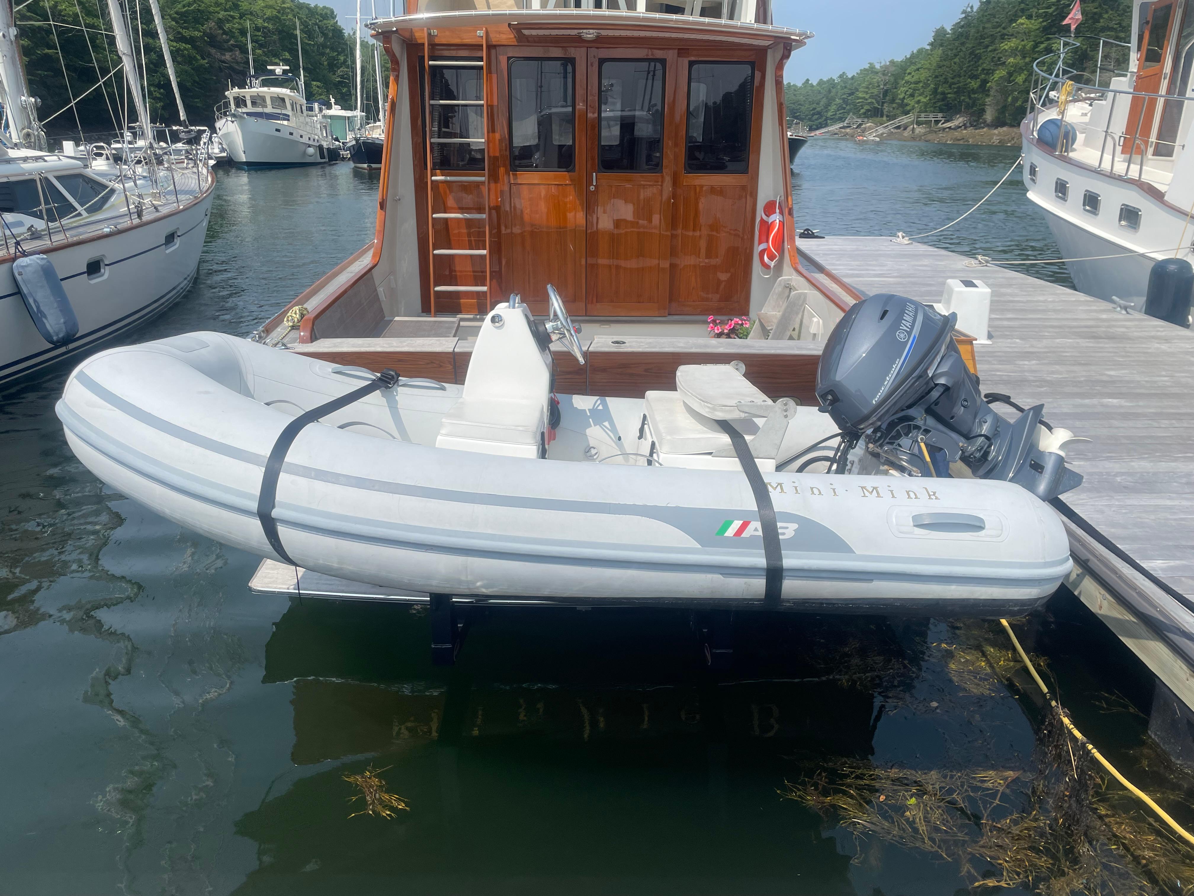 1997 Lyman-Morse Custom Flybridge with inflatable dinghy docked in a marina.