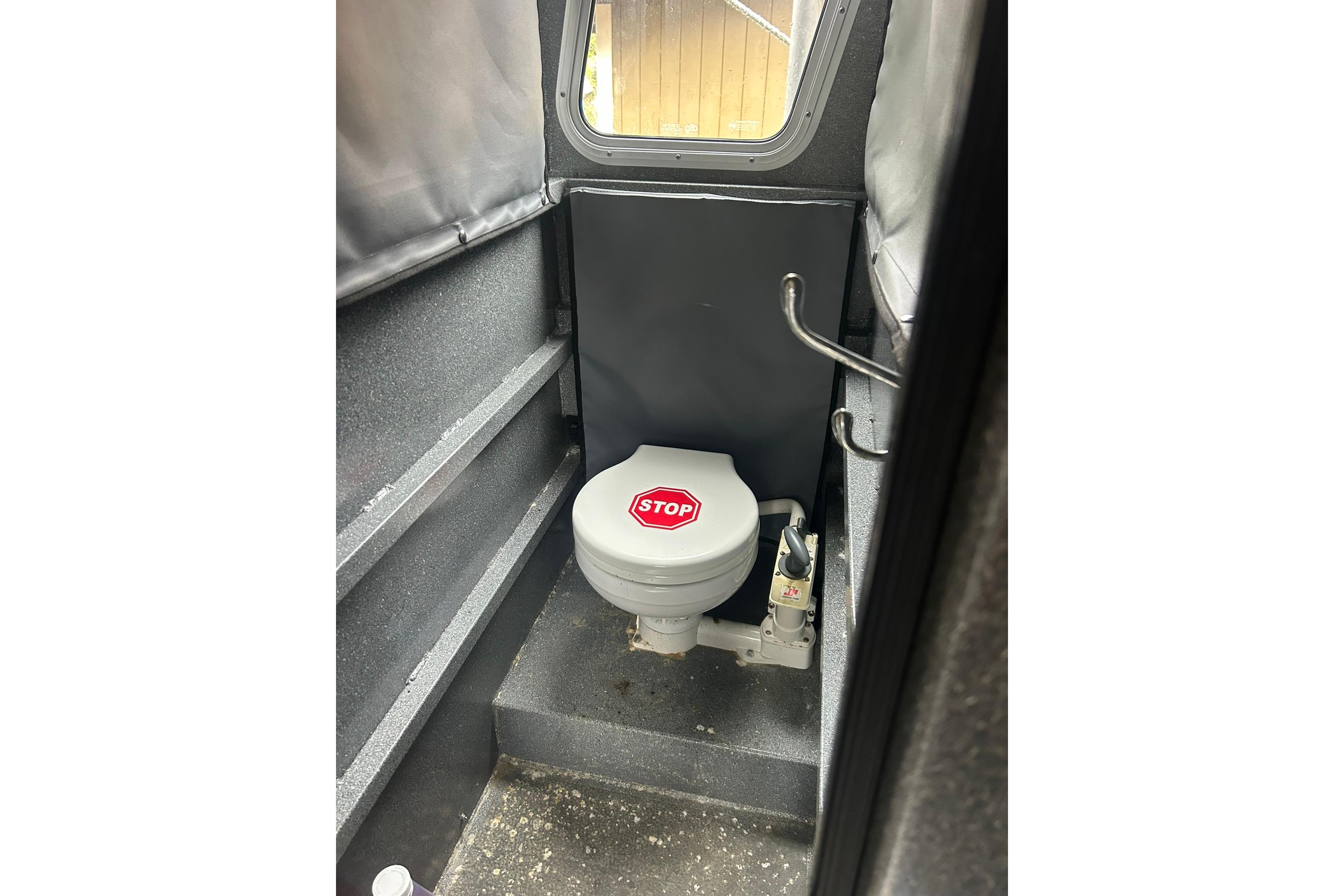 2016 North River 29 OFFSHORE boat interior with compact marine toilet.