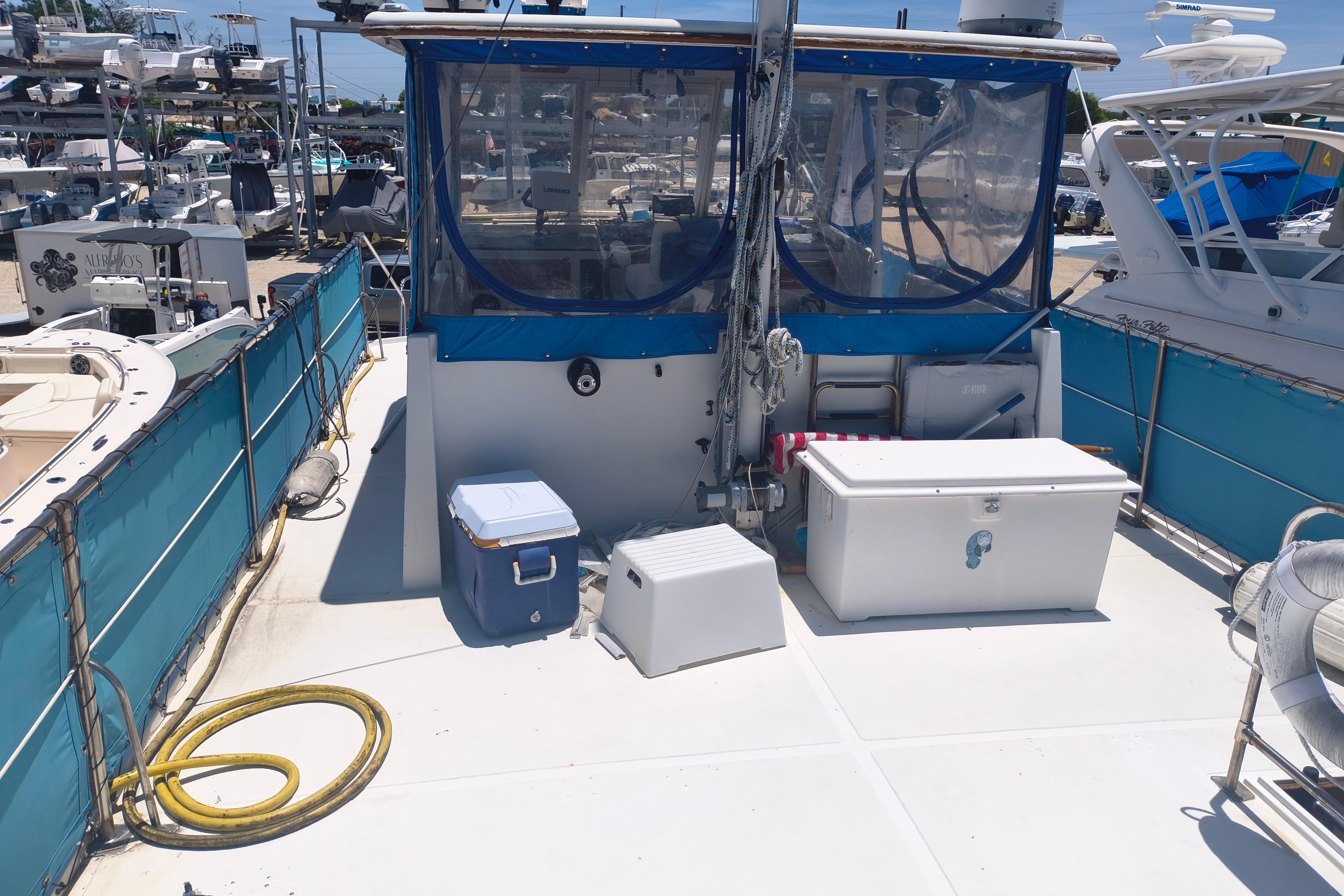 1984 Kadey-Krogen Manatee boat deck with storage boxes and marine equipment.