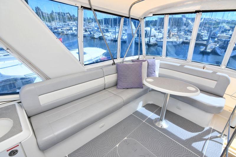 Luxurious interior of 2008 Carver 43 Super Sport yacht with marina view.