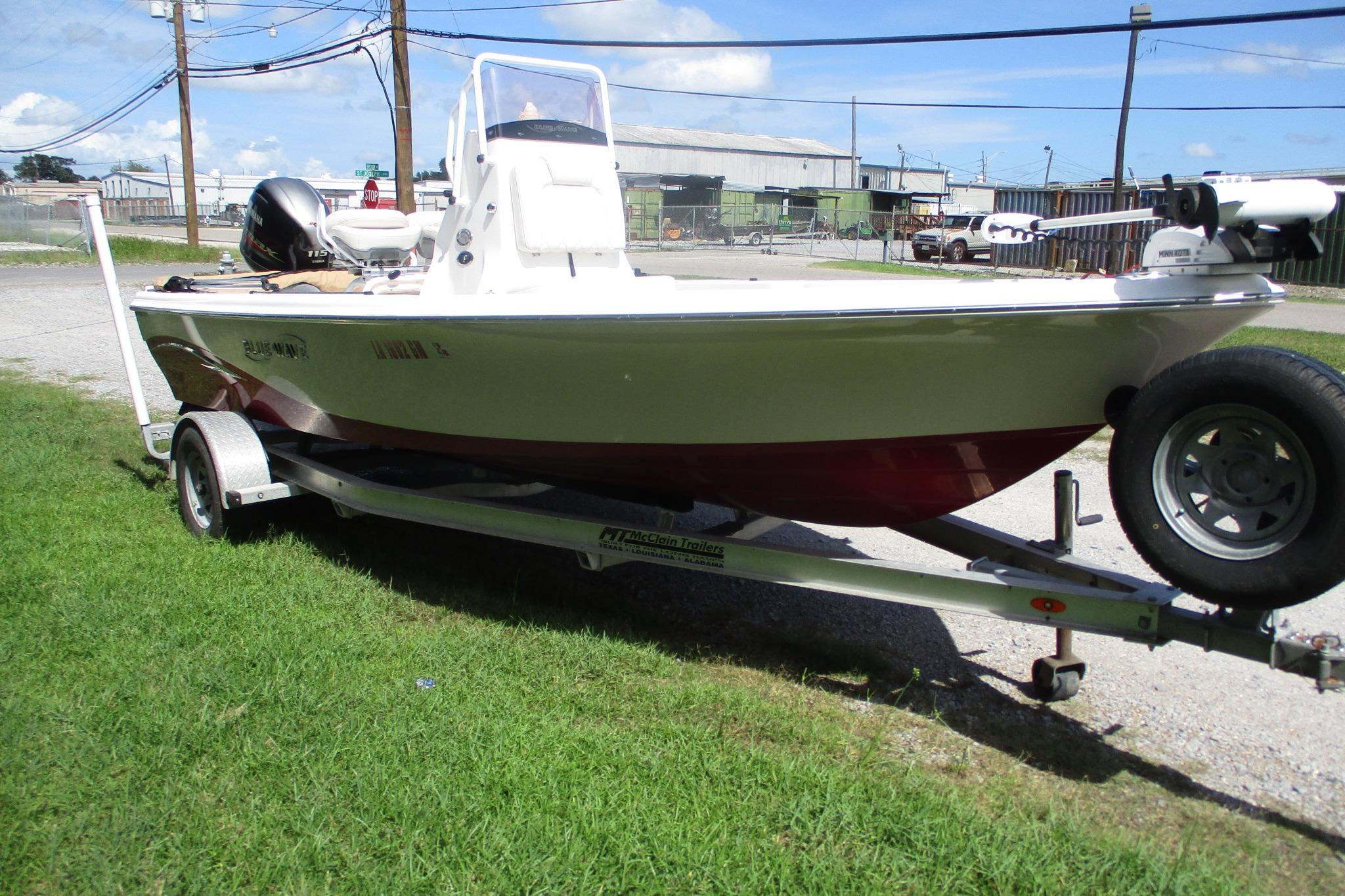 2021 Blue Wave 2000 PureBay boat on trailer, parked on grass under clear sky.