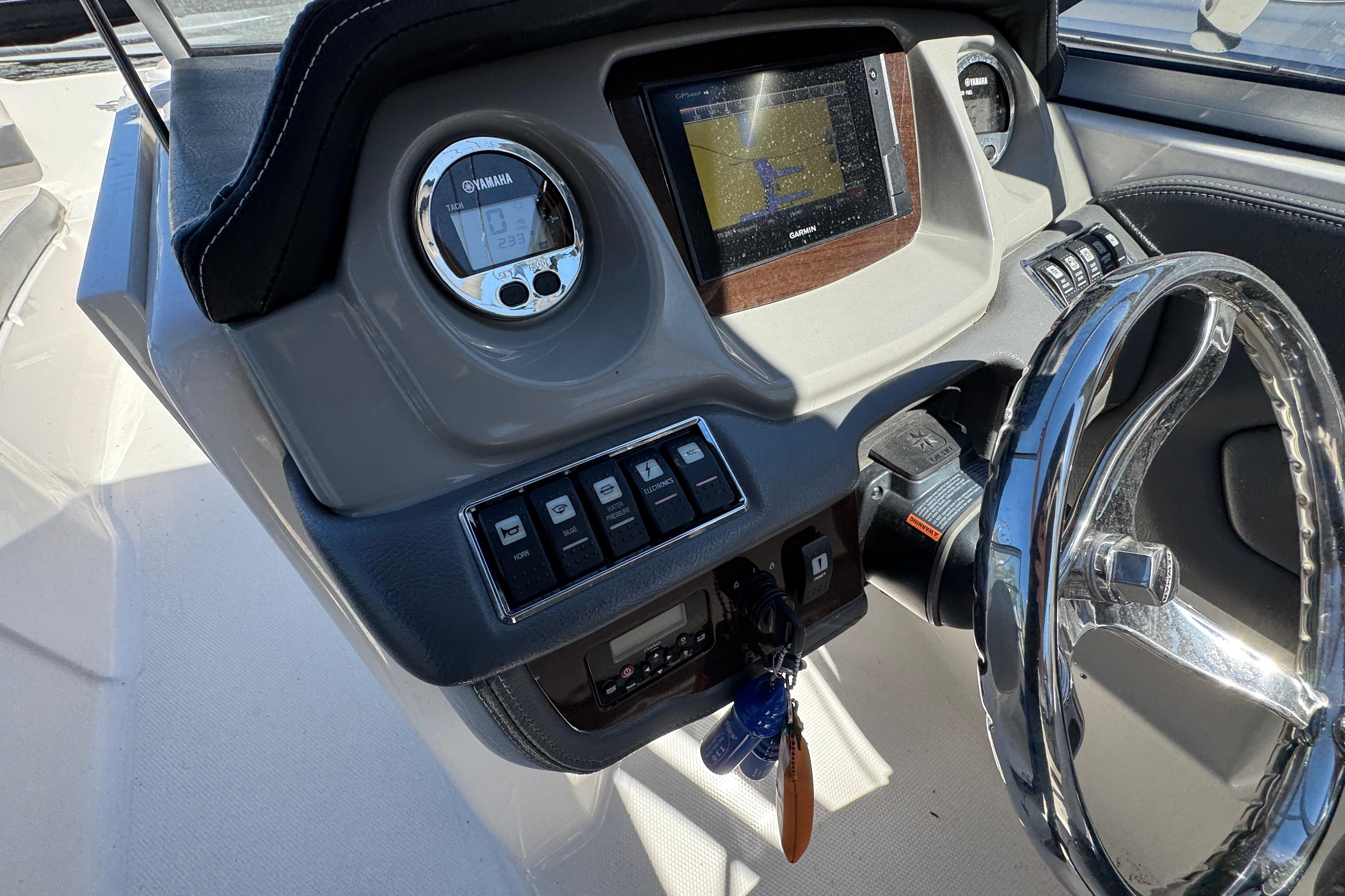 2018 Chaparral 250 Suncoast dashboard with steering wheel and navigation display.