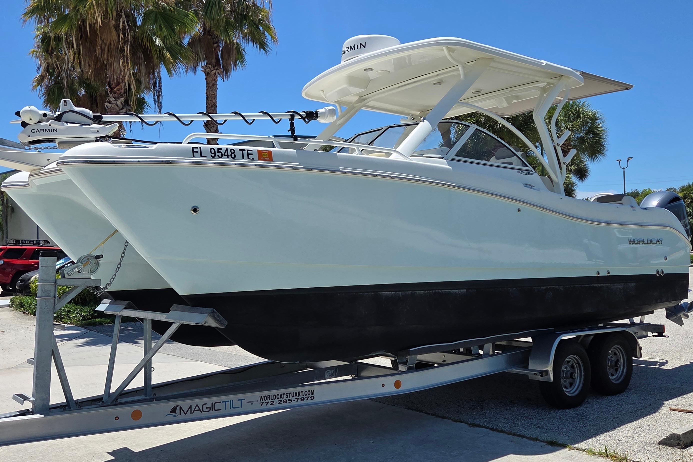 2022 World Cat 255 DC boat on trailer, parked outdoors under clear sky.