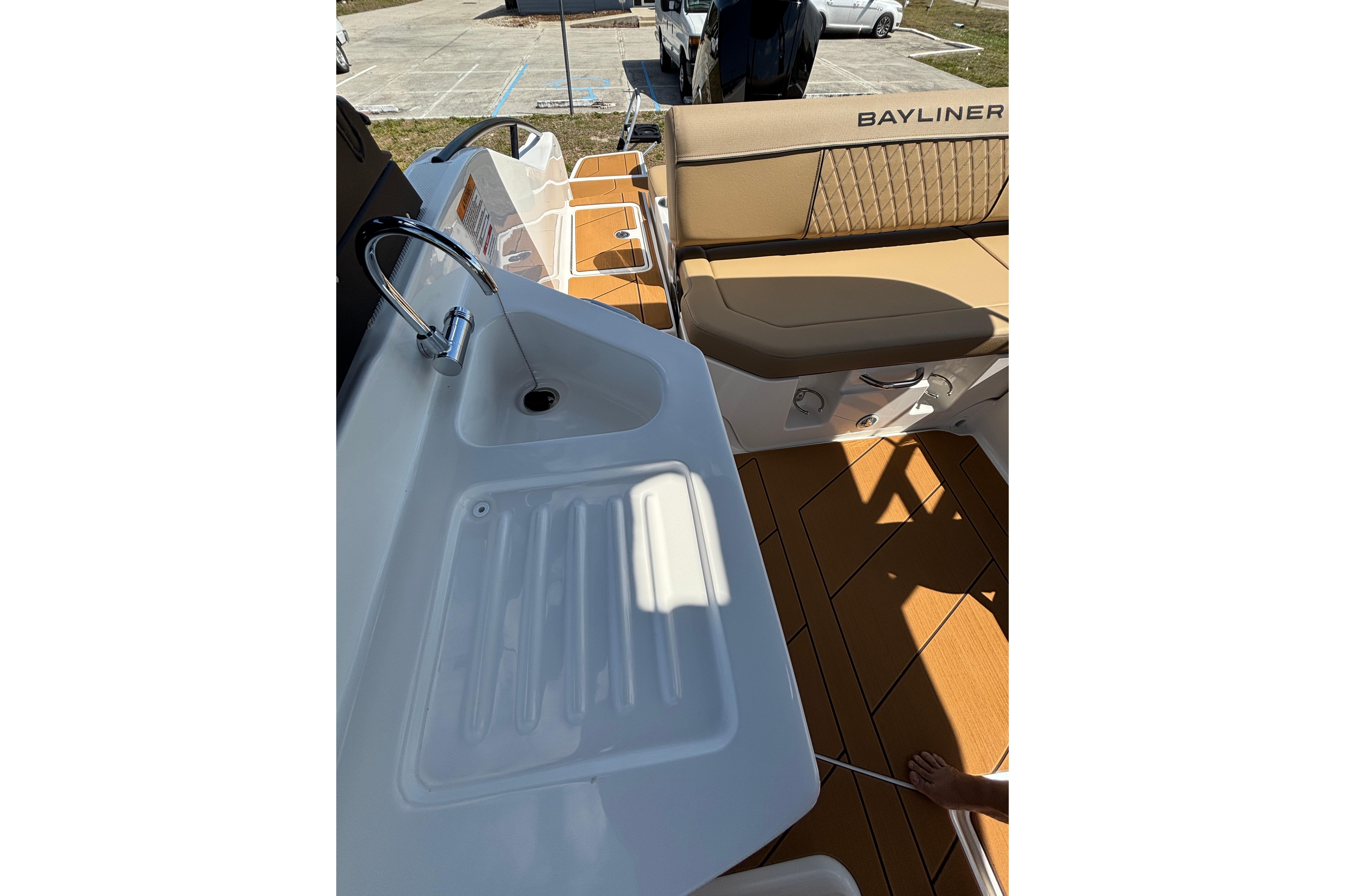 2026 Bayliner D22 boat interior with sink and seating area.
