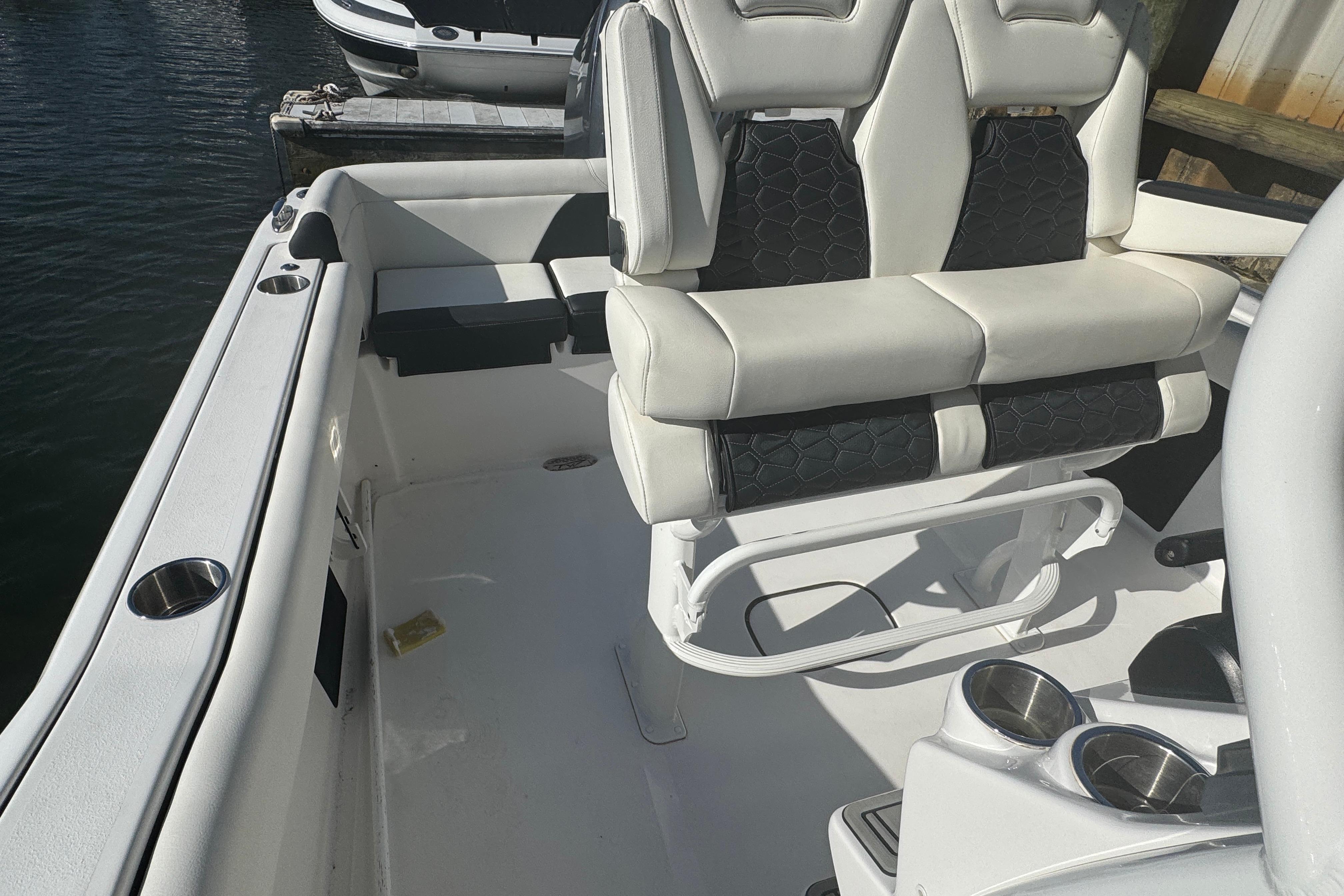 2025 Tidewater 232 LXF boat interior with cushioned seating and cup holders.