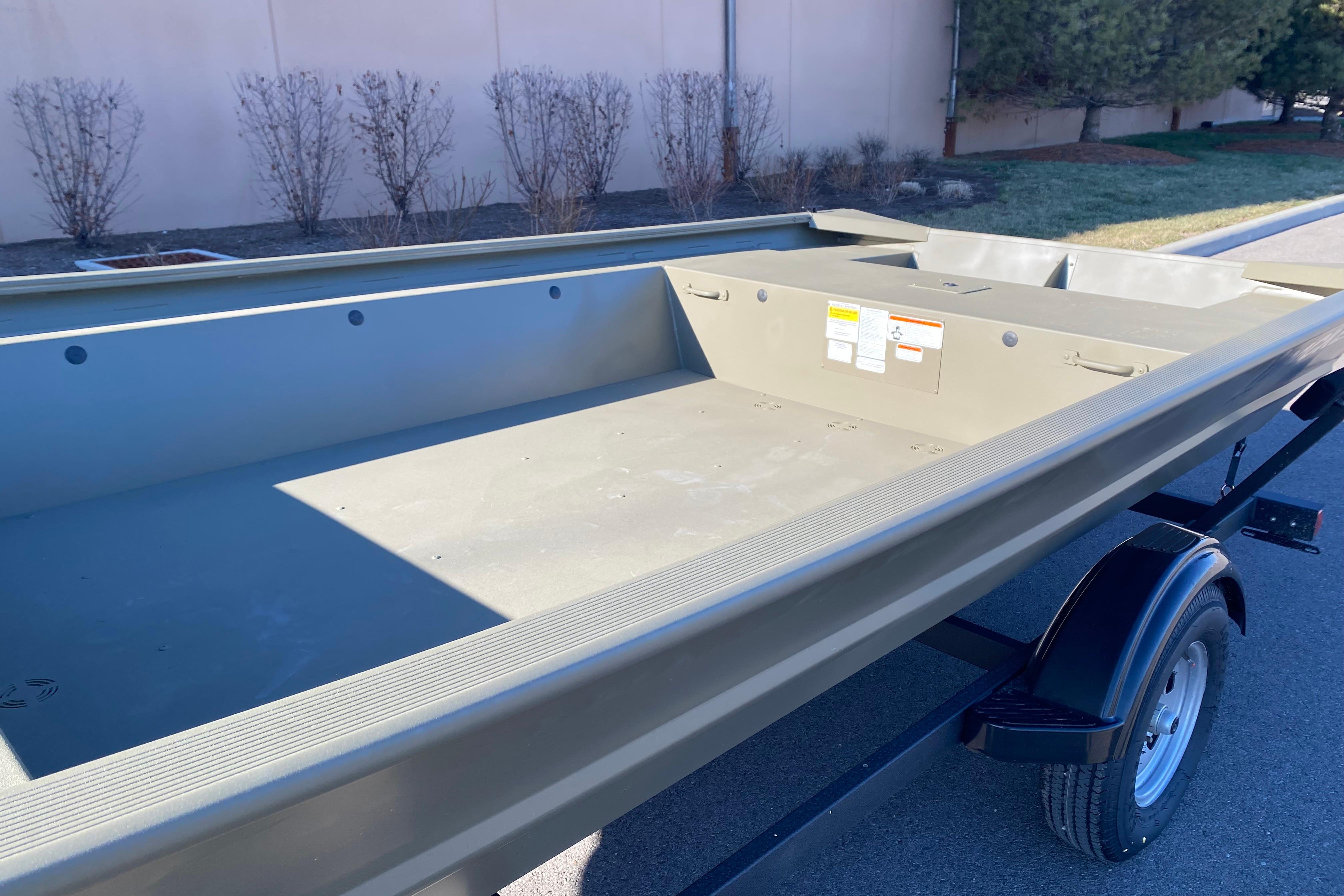 2026 Tracker Grizzly 1754 Utility boat on trailer, parked outdoors.