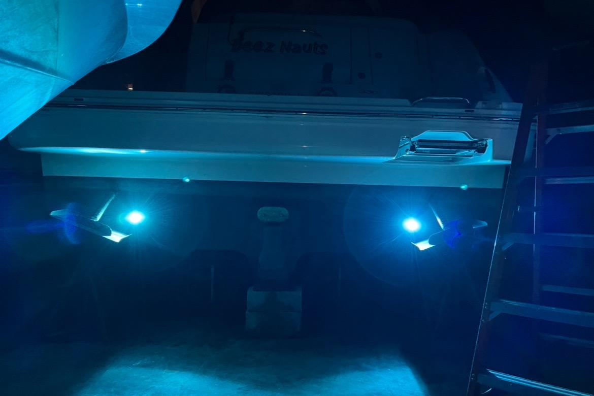 2008 Sea Ray 350 Sundancer with illuminated underwater lights at night.