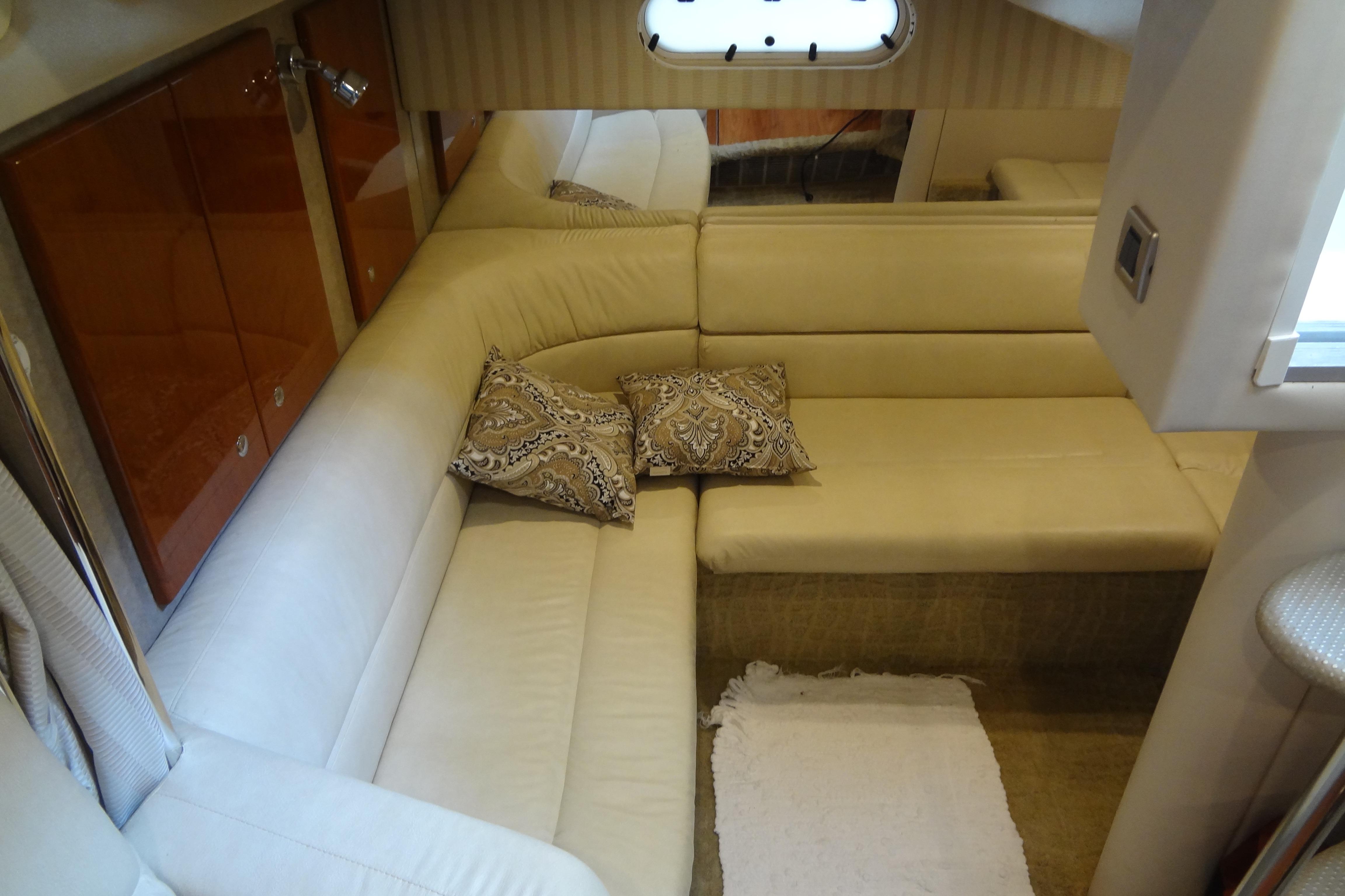 Interior of 2007 Formula 34 Performance Cruiser with beige seating and decorative pillows.