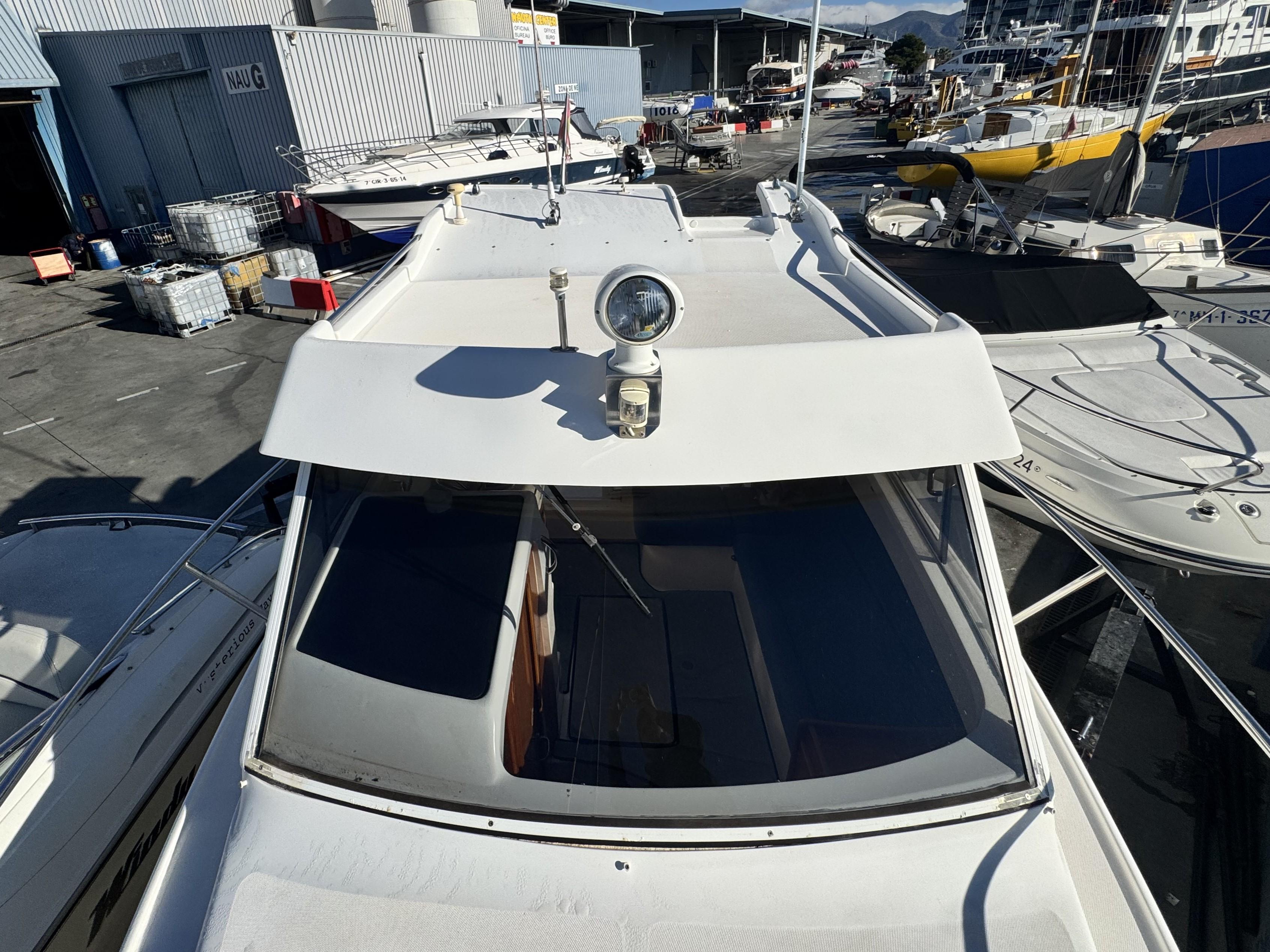 2002 RIO 800 Cabin Fish boat docked at a marina, top view.