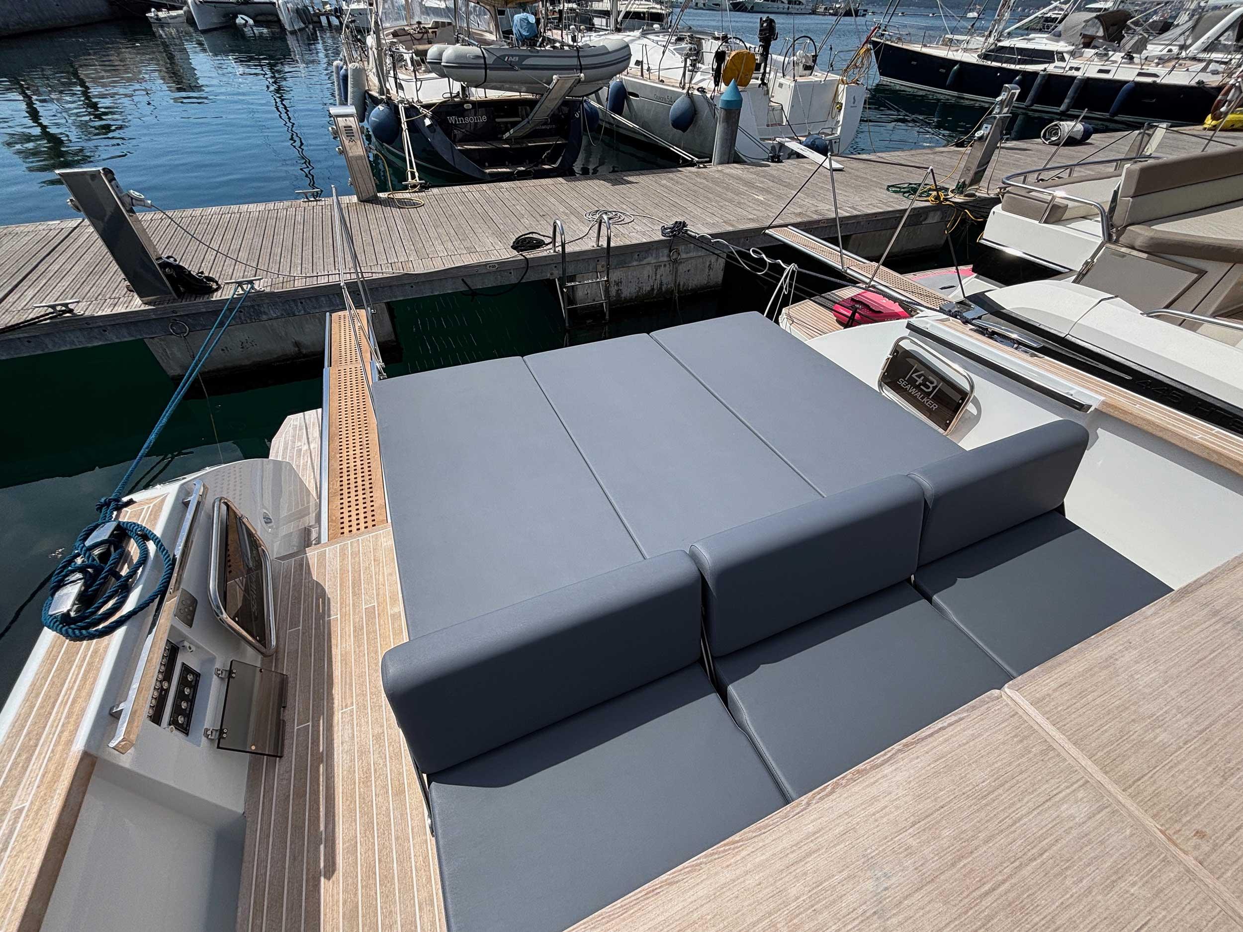 2024 Fiart 43 Seawalker yacht with spacious sunbed at marina dock.
