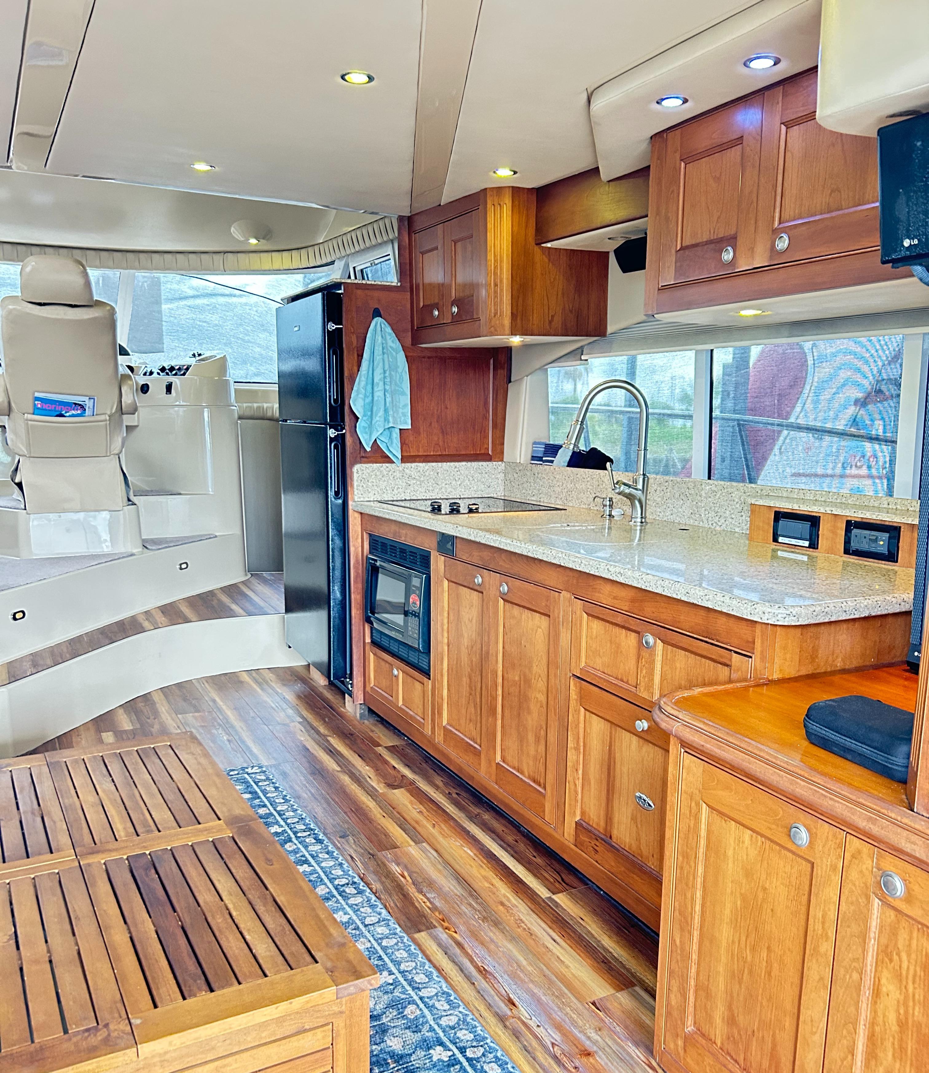 2004 Cruisers Yachts 5000 Sedan Sport interior with wood cabinetry and modern kitchen amenities.