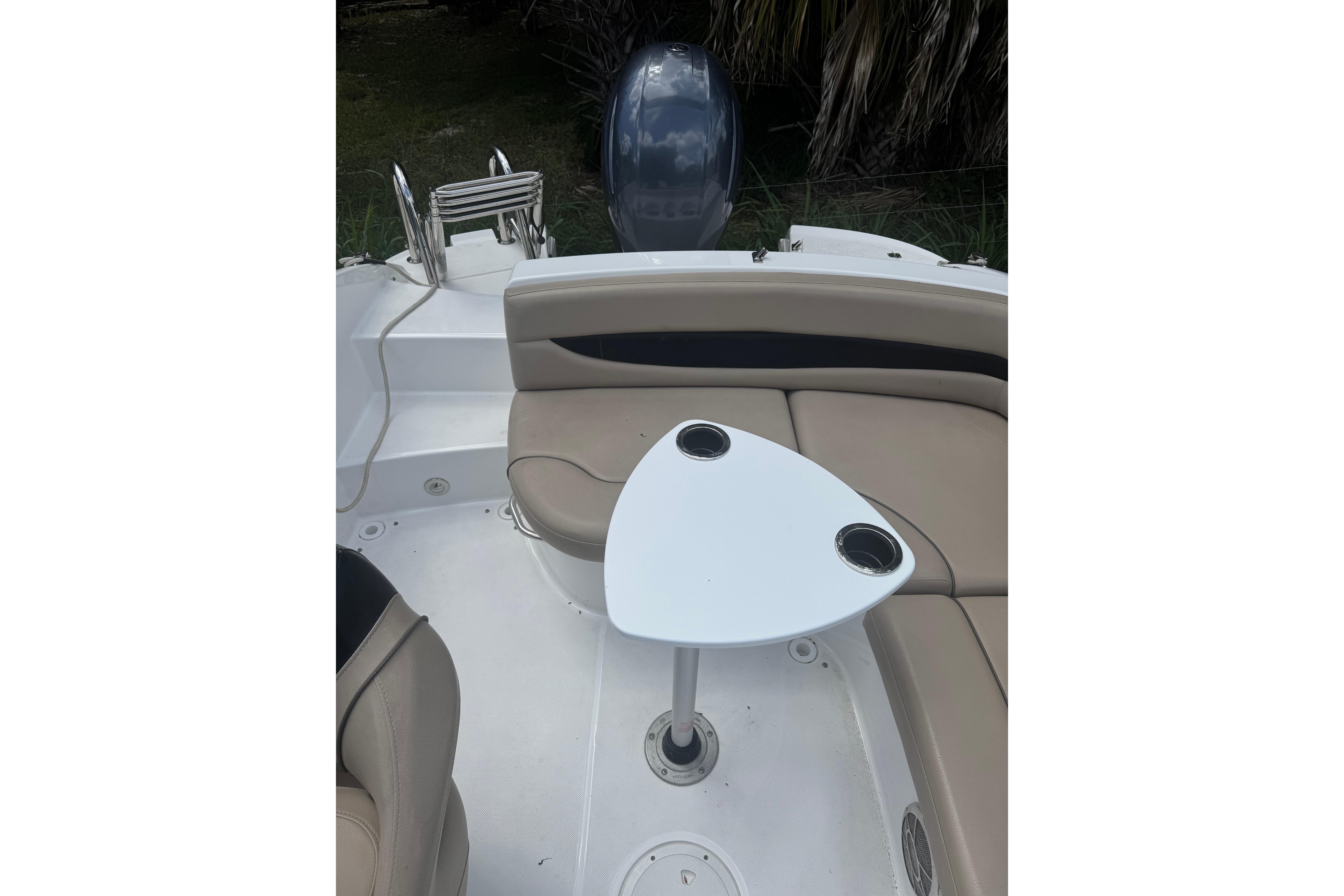 2016 Hurricane SunDeck Sport 203 OB boat interior with seating and table.