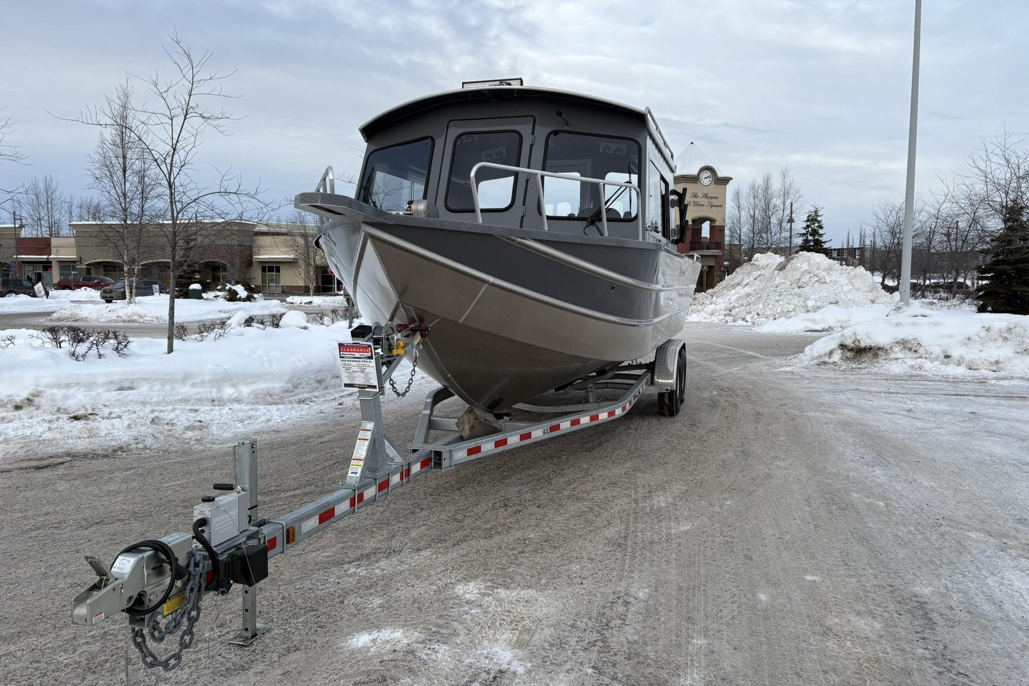 2024 Spartan 26 Maximus Pro XL boat on trailer in snowy parking lot.