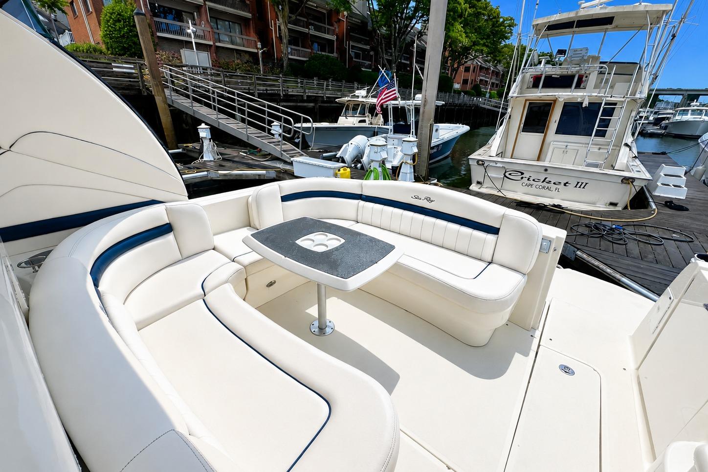 Luxurious 2006 Sea Ray 40 Sundancer yacht with elegant seating at marina.