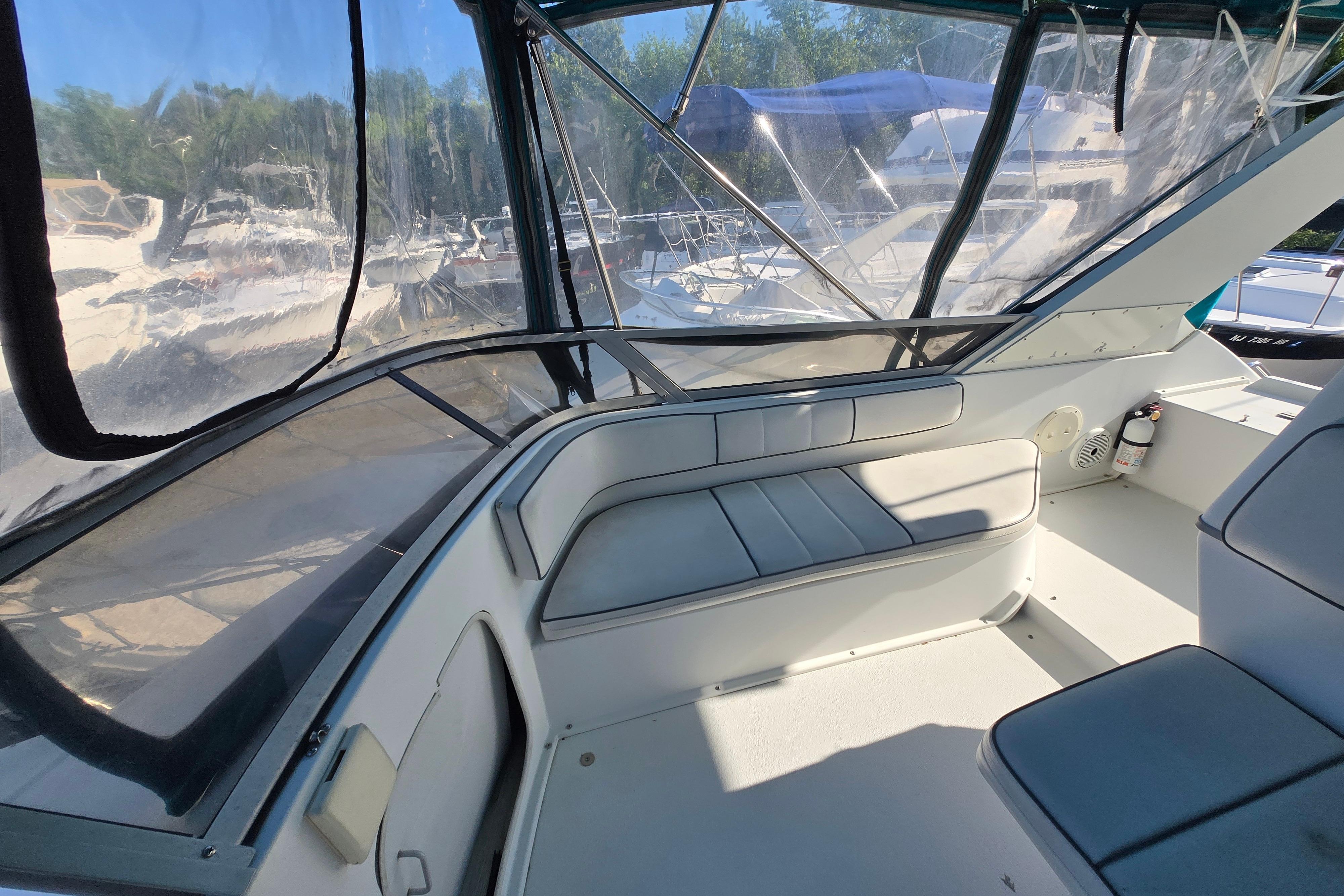 Interior view of a 1994 Carver 380 Santego yacht with seating and clear windows.