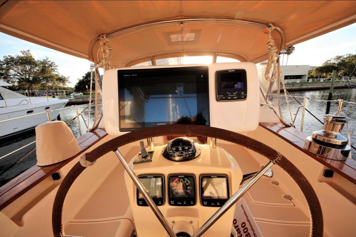 Cockpit view of 2000 Island Packet 420 sailboat with navigation equipment and steering wheel.