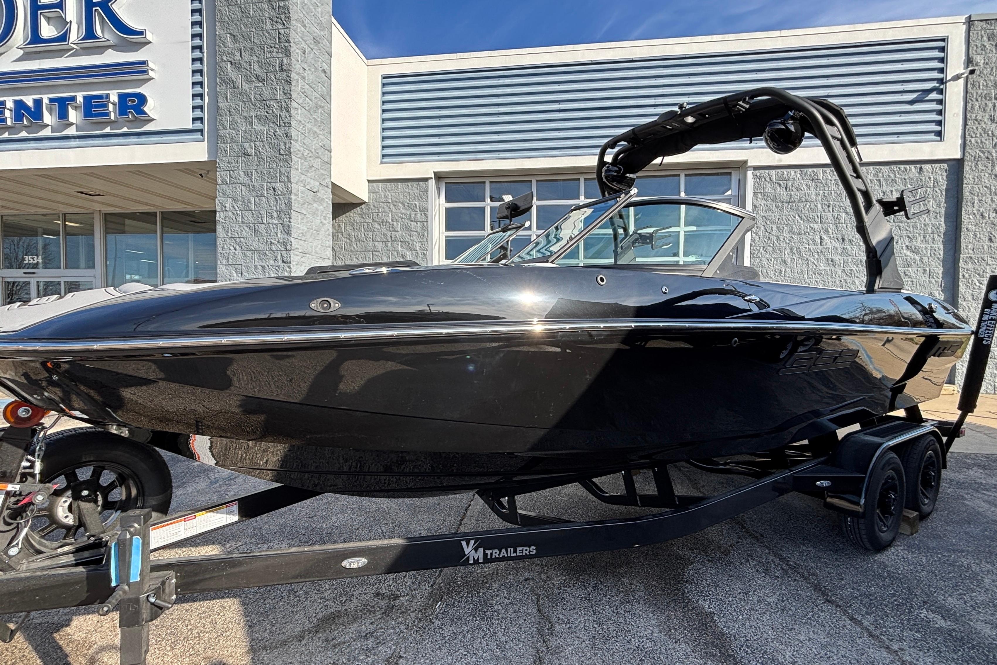 2026 MB B52 23 Classic boat on trailer outside dealership.