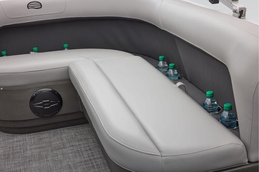 Interior seating of 2026 Sun Tracker Party Barge 16 DLX with cup holders and speaker.