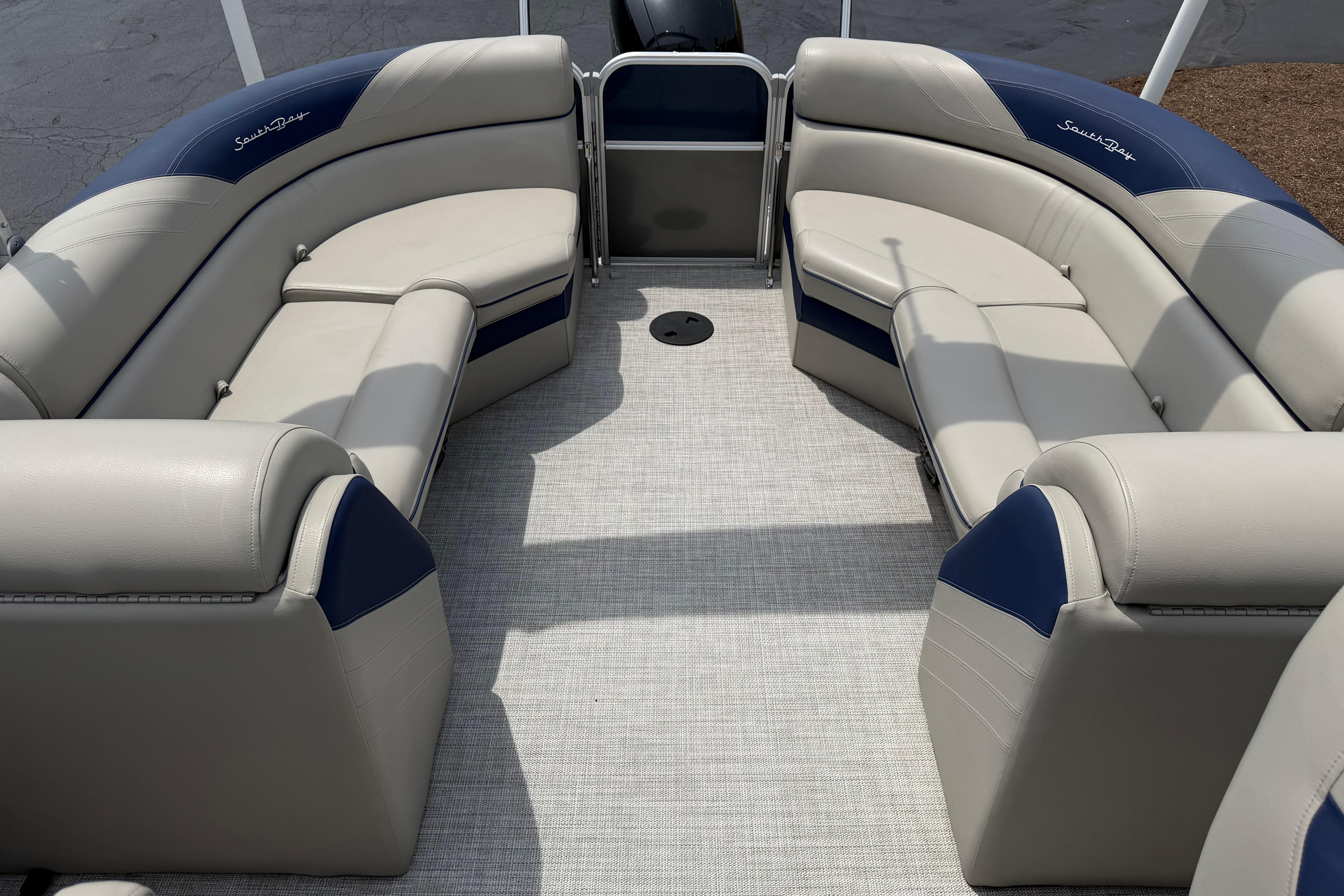 2021 South Bay 224RS LE pontoon boat interior with beige and blue seating.