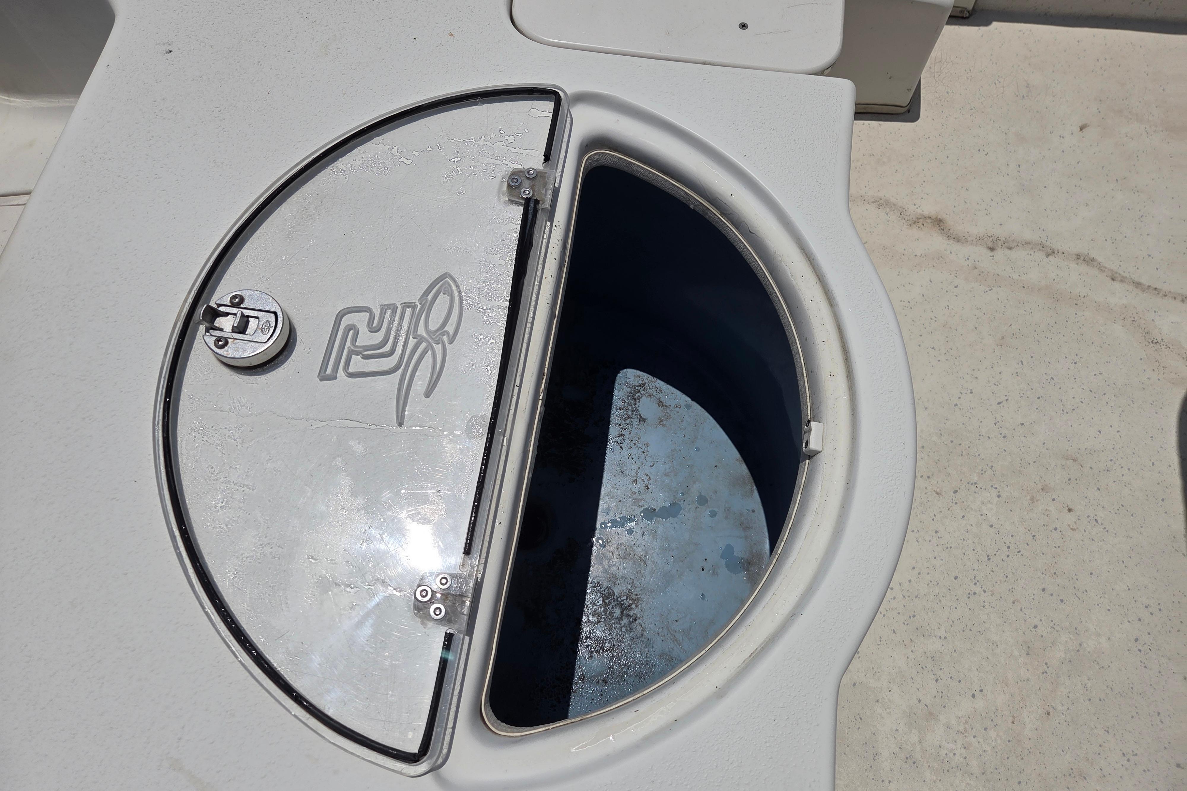 2016 Carolina Skiff 198 DLV boat compartment with circular hatch and latch.