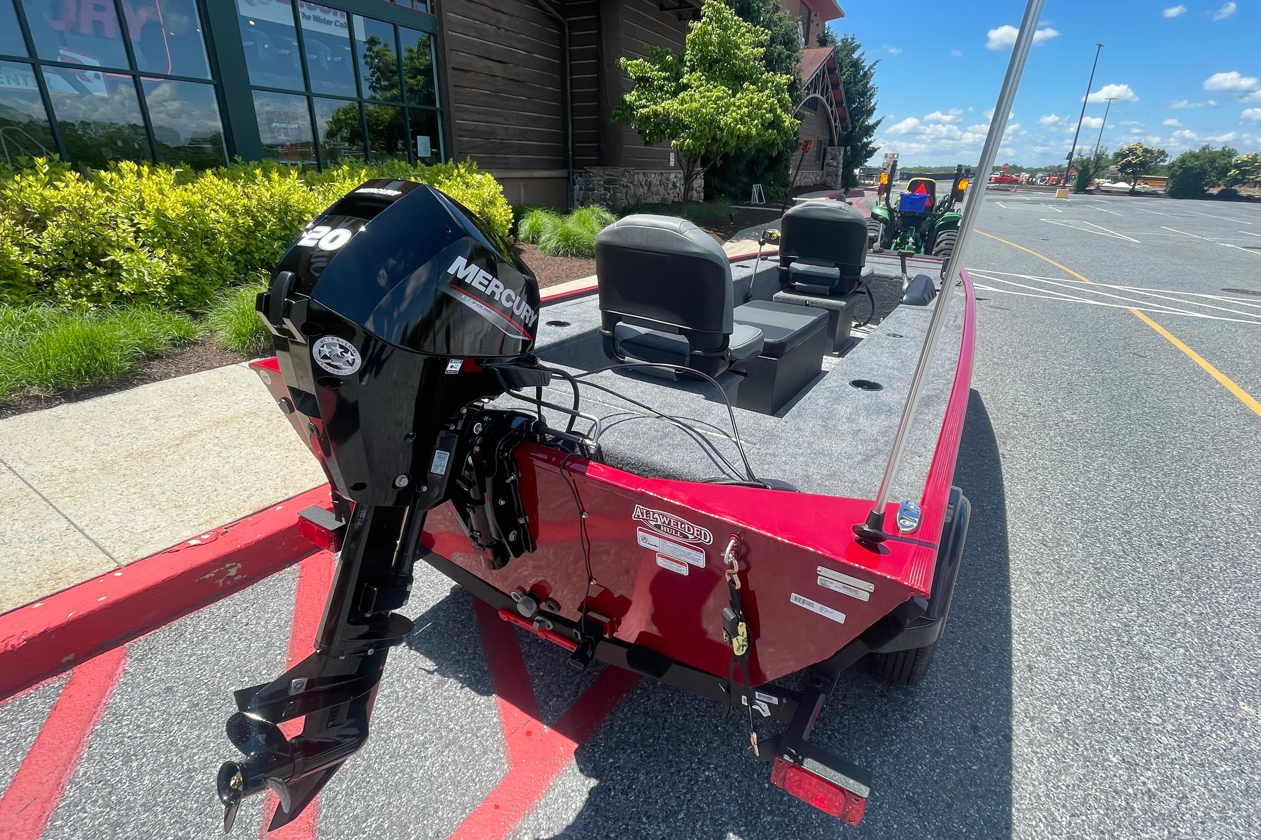 2026 Tracker Panfish 17 boat with Mercury engine in parking lot.